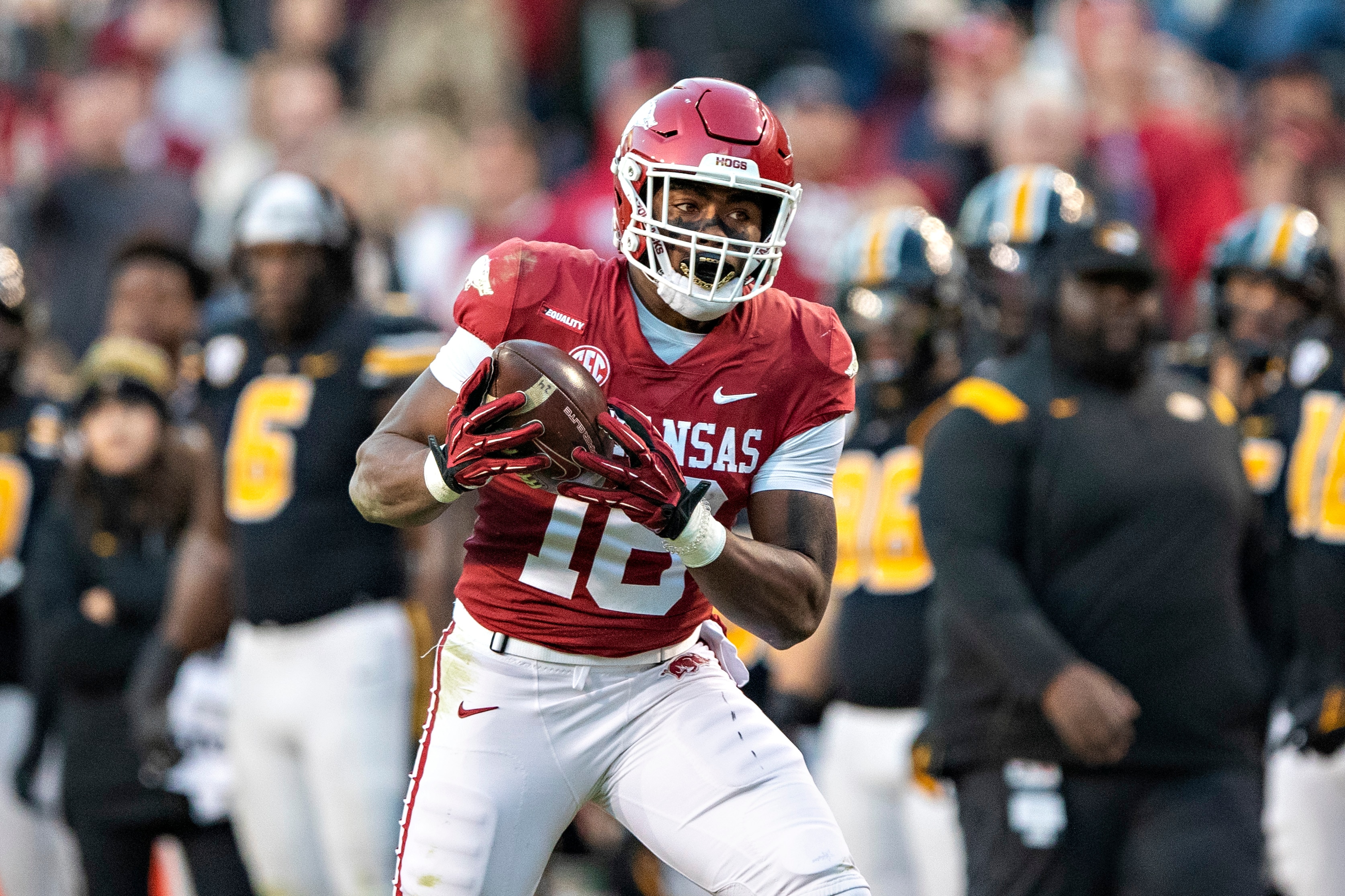 FAYETTEVILLE, ARKANSAS - NOVEMBER 26: Treylon Burks #16 of the Arkansas Razorbacks catches a pass for a touchdown during a game against the Missouri Tigers at Donald W. Reynolds Razorback Stadium on November 26, 2021 in Fayetteville, Arkansas. The Razorbacks defeated the Tigers 34-17.  (Photo by Wesley Hitt/Getty Images)