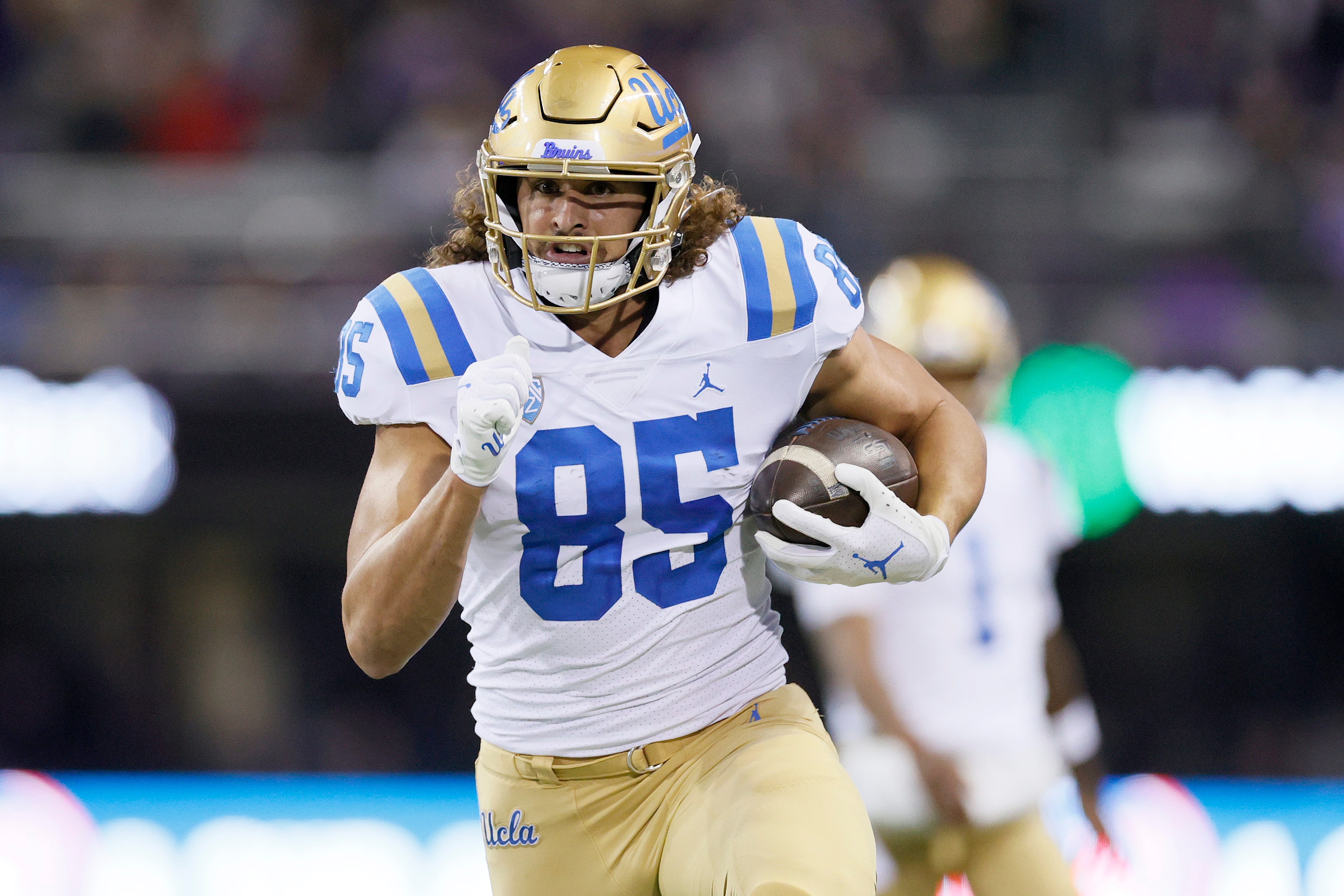 SEATTLE, WASHINGTON - OCTOBER 16: Greg Dulcich #85 of the UCLA Bruins carries the ball against the Washington Huskies during the fourth quarter at Husky Stadium on October 16, 2021 in Seattle, Washington. (Photo by Steph Chambers/Getty Images)