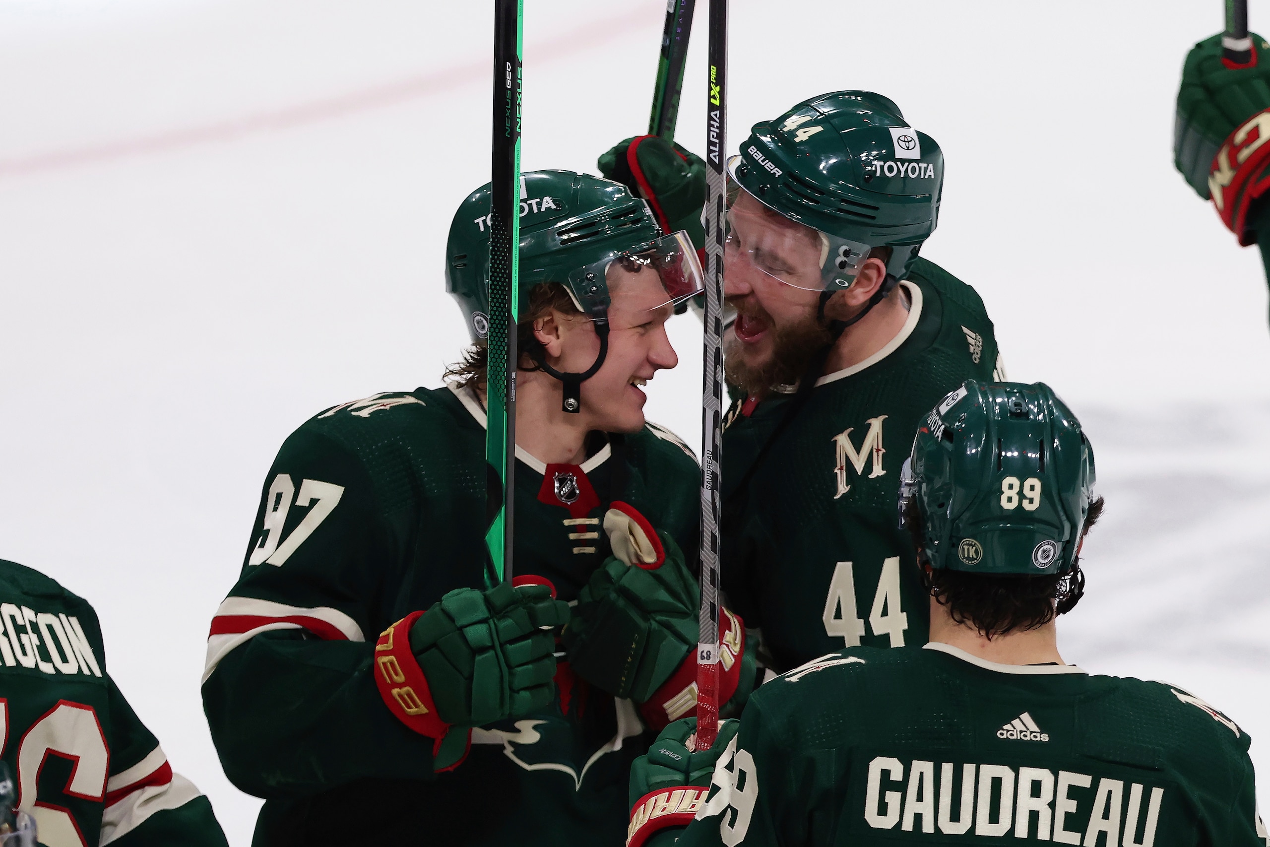 Minnesota Wild left wing Kirill Kaprizov (97) celebrates with teammate left wing Nicolas Deslauriers (44) after defeating the Seattle Kraken in an NHL hockey game, Friday, April 22, 2022, in St. Paul, Minn. (AP Photo/Stacy Bengs)