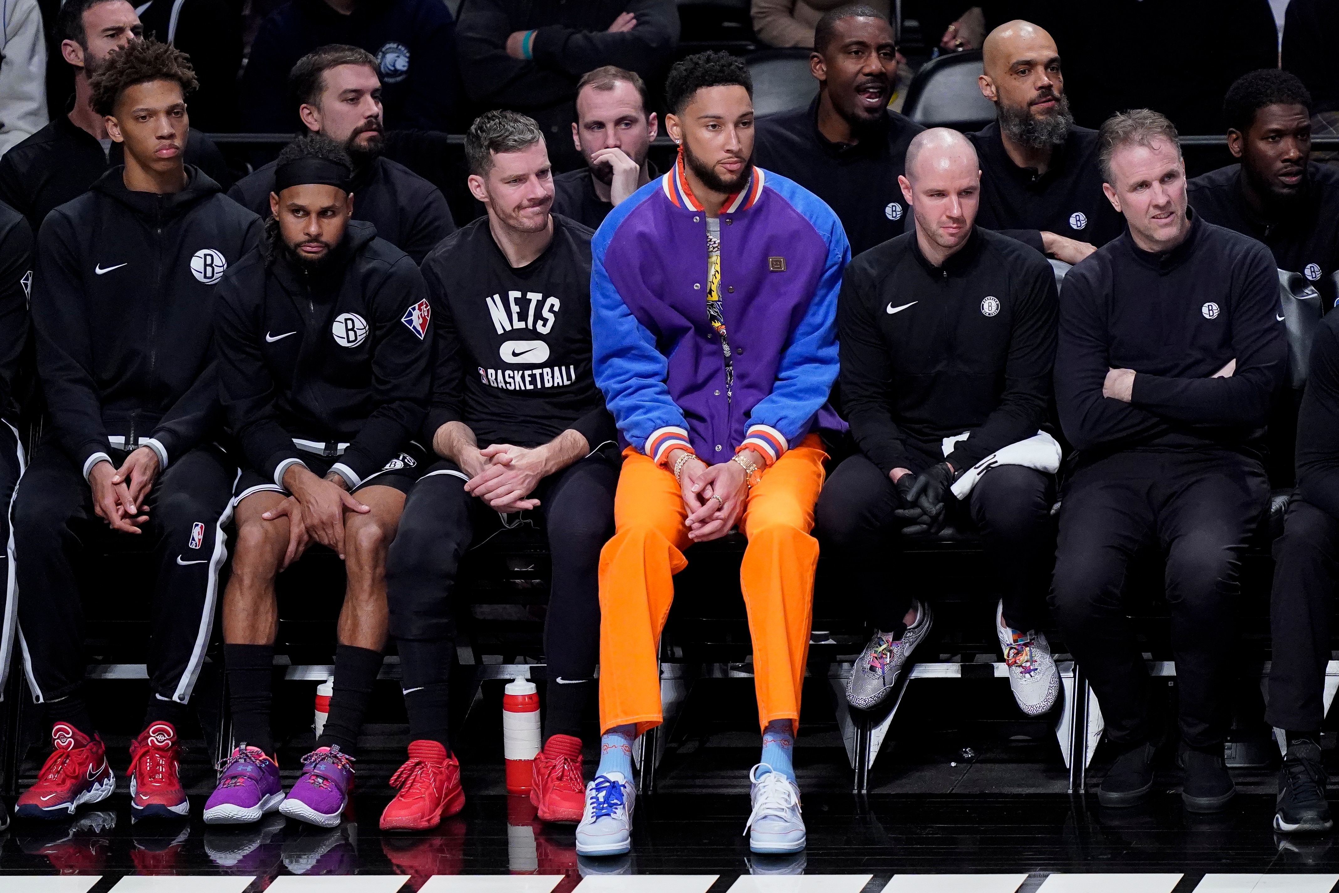 Brooklyn Nets' Ben Simmons, center, sits on the bench during the second half of Game 3 of an NBA basketball first-round playoff series against the Boston Celtics, Saturday, April 23, 2022, in New York. (AP Photo/John Minchillo)