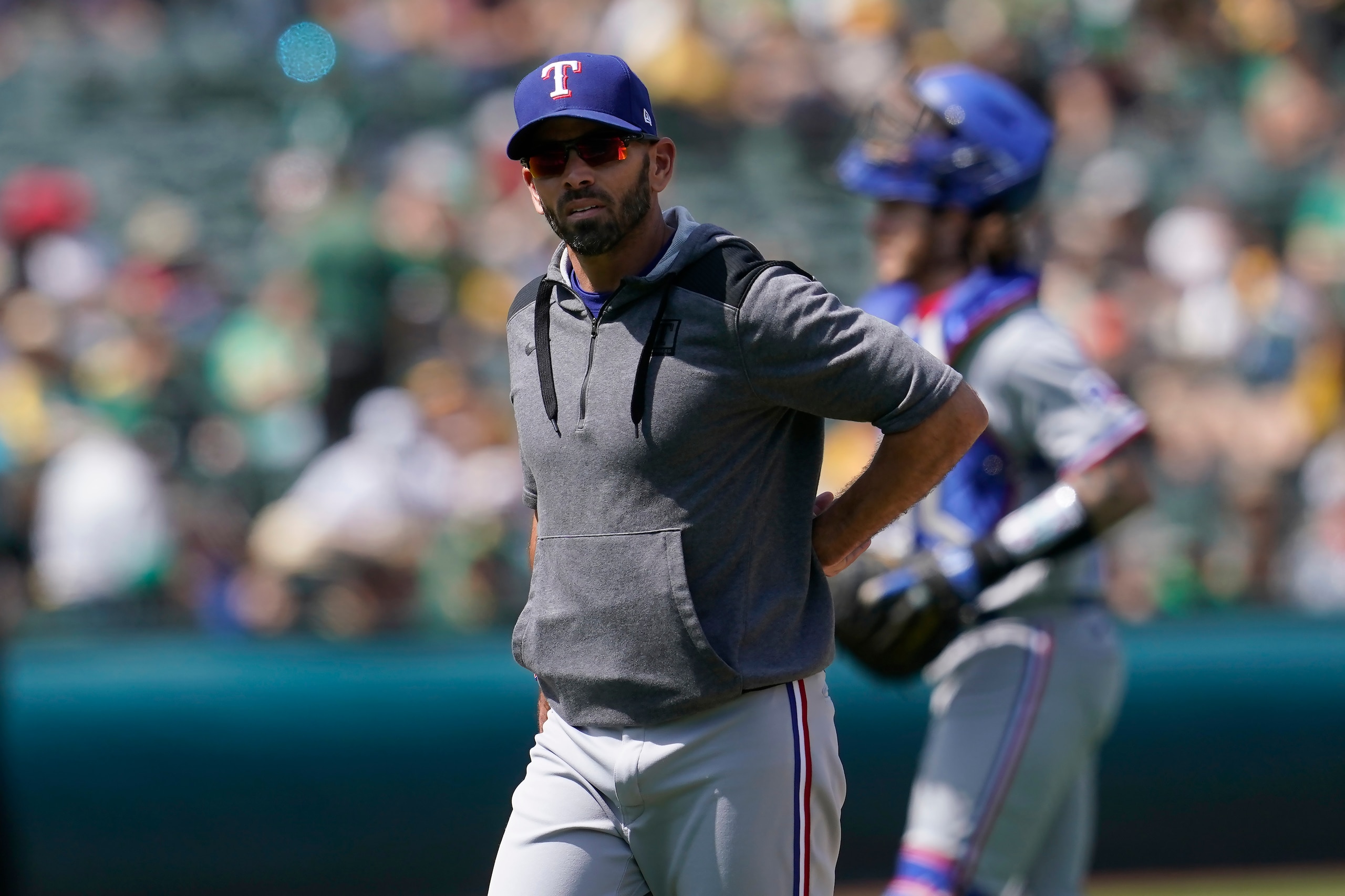 Texas Rangers manager Chris Woodward walks to the dugout after making a pitching change during the fifth inning of his team's baseball game against the Oakland Athletics in Oakland, Calif., Sunday, April 24, 2022. (AP Photo/Jeff Chiu)