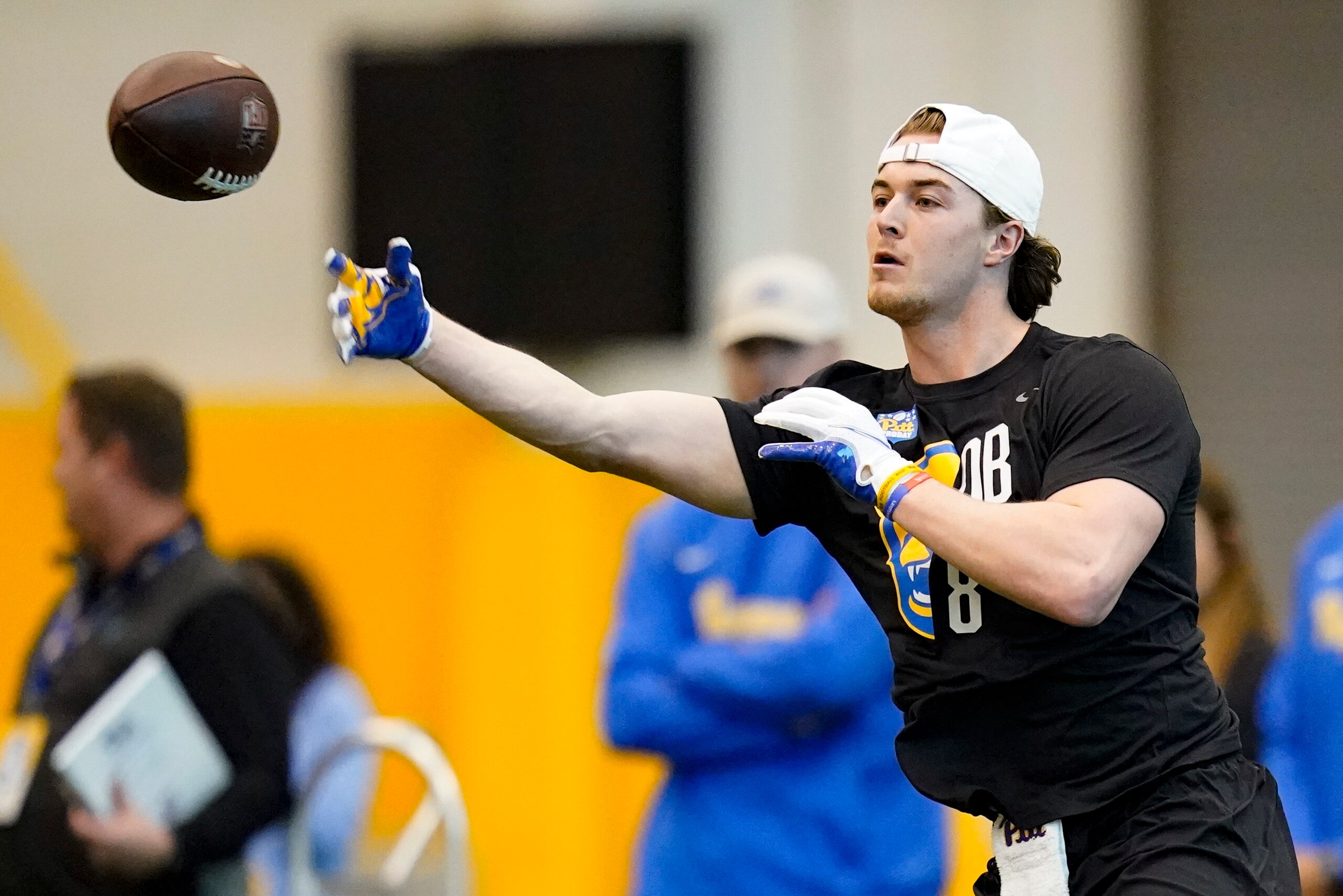 Quarterback Kenny Pickett (8) goes through passing drills during Pittsburgh's football pro day , Monday, March 21, 2022, in Pittsburgh. (AP Photo/Keith Srakocic)