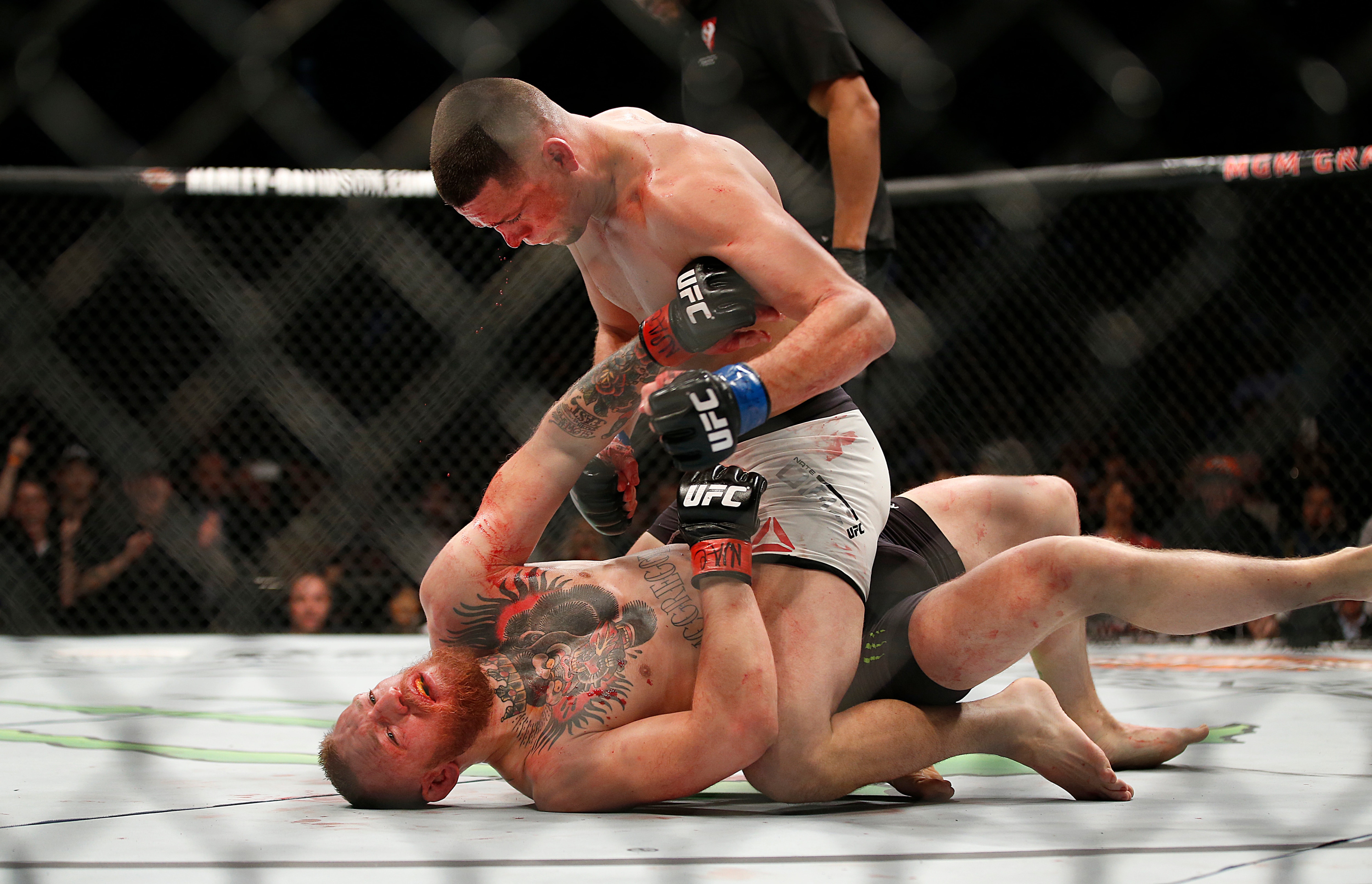 FILE - In this March 5, 2016 file photo, Nate Diaz, top, trades punches Conor McGregor during their UFC 196 welterweight mixed martial arts match, in Las Vegas. Diaz defeated McGregor. (AP Photo/Eric Jamison)