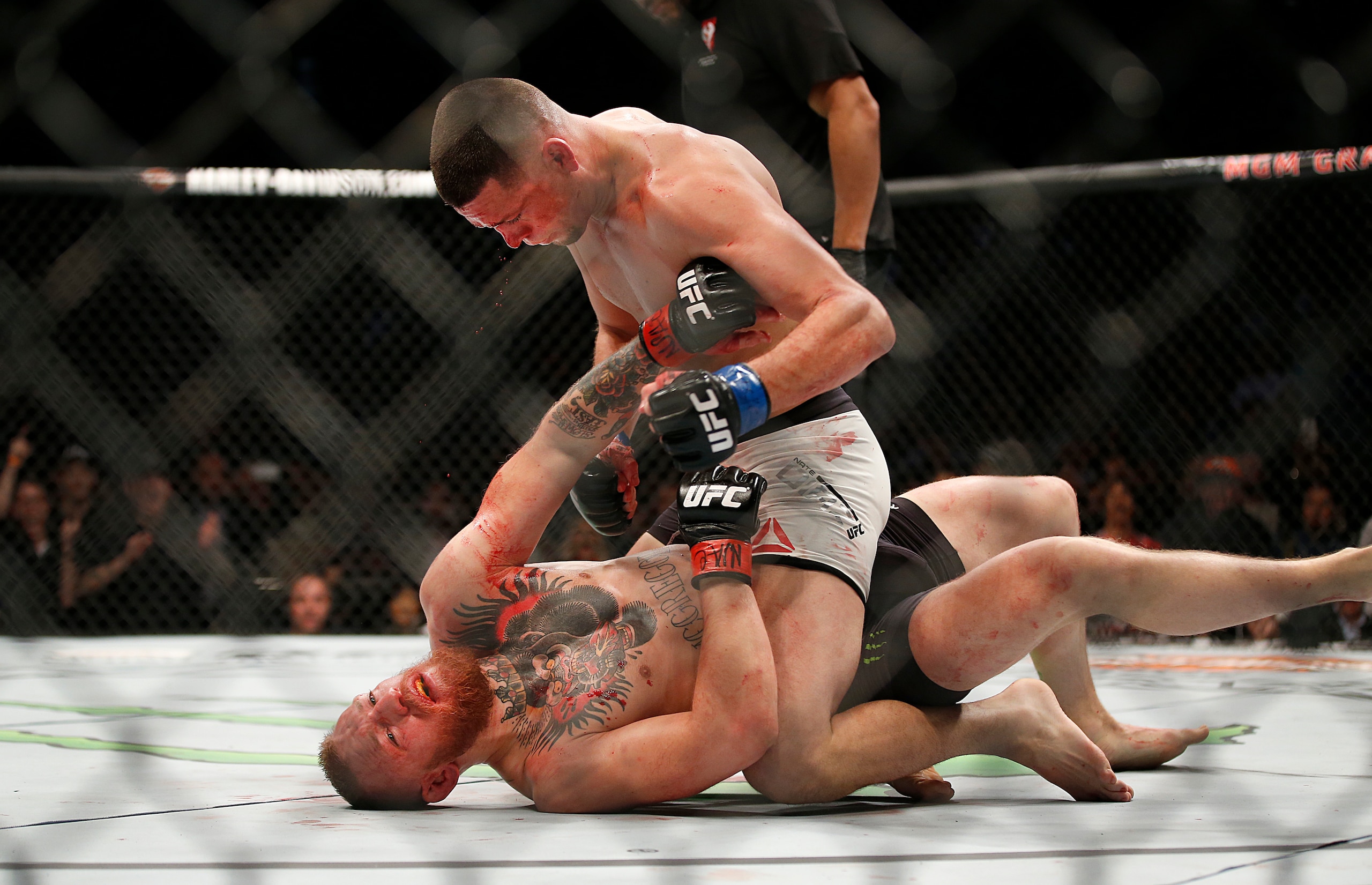 FILE - In this March 5, 2016 file photo, Nate Diaz, top, trades punches Conor McGregor during their UFC 196 welterweight mixed martial arts match, in Las Vegas. Diaz defeated McGregor. (AP Photo/Eric Jamison)