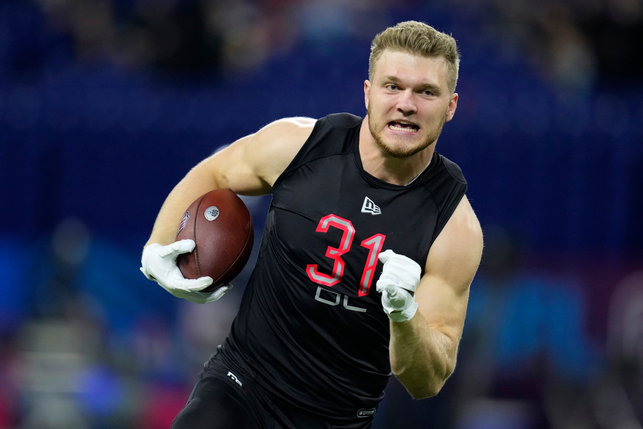 Michigan defensive lineman Aidan Hutchinson runs during a drill at the NFL football scouting combine, Saturday, March 5, 2022, in Indianapolis. (AP Photo/Charlie Neibergall)