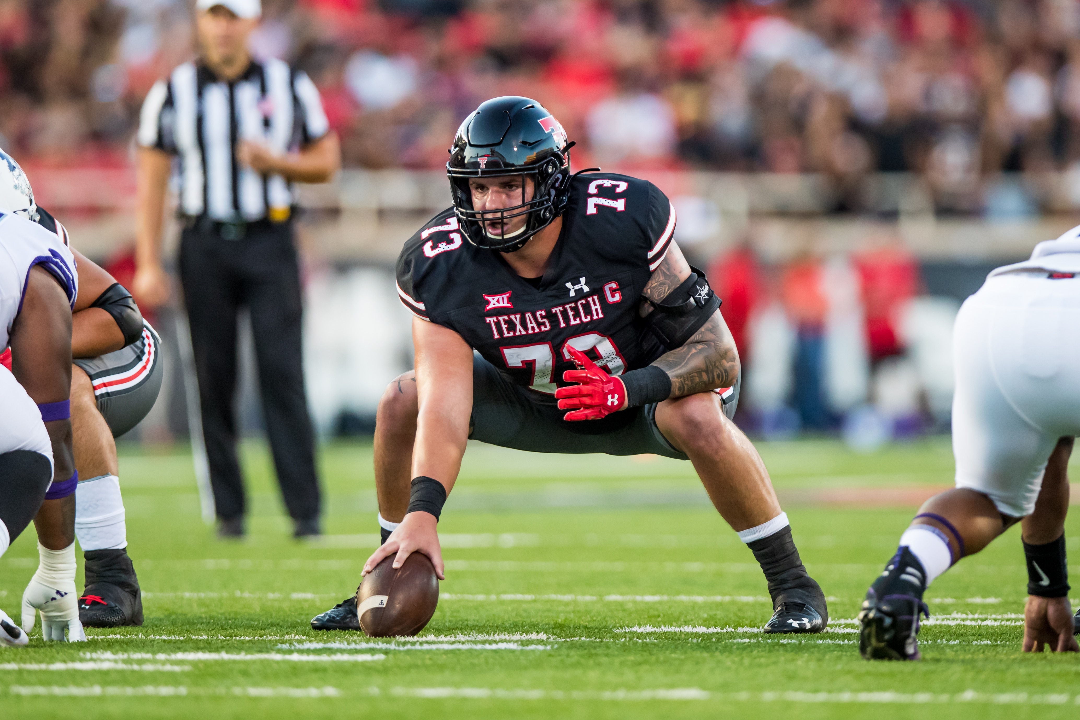 LUBBOCK, TEXAS - OCTOBER 09: Offensive lineman Dawson Deaton #73 of the Texas Tech Red Raiders prepares to snap the ball during the first half of the college football game against the TCU Horned Frogs at Jones AT&T Stadium on October 09, 2021 in Lubbock, Texas. (Photo by John E. Moore III/Getty Images)