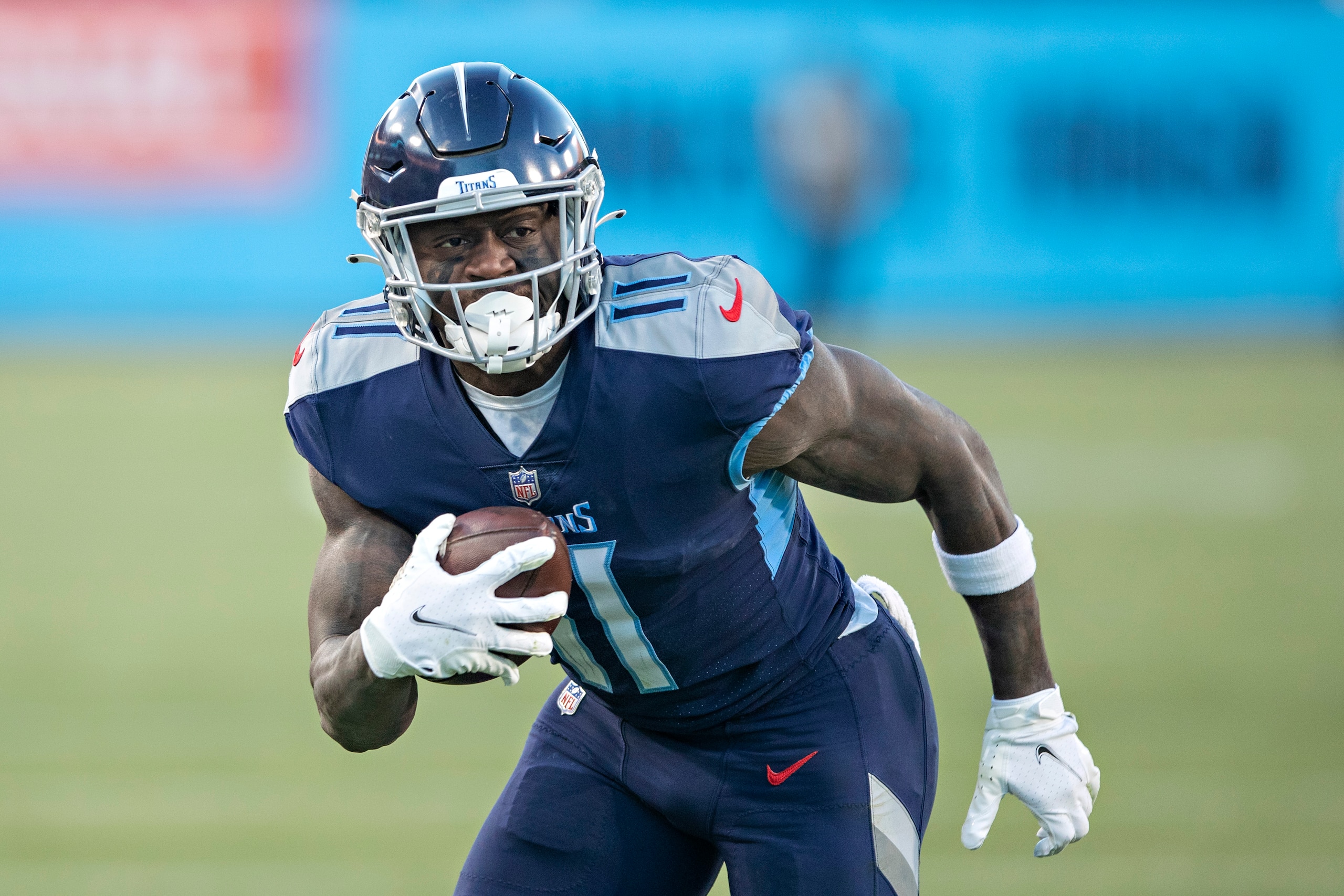 NASHVILLE, TENNESSEE - JANUARY 22: A.J. Brown #11 of the Tennessee Titans runs the ball during a game against the Cincinnati Bengals in the AFC Divisional Playoff game at Nissan Stadium on January 22, 2022 in Nashville, Tennessee. The Bengals defeated the Titans 19-16.  (Photo by Wesley Hitt/Getty Images)
