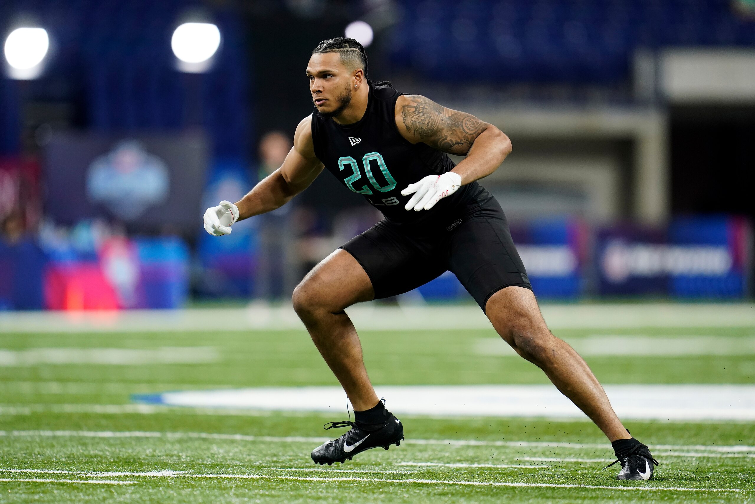 Florida State linebacker Jermaine Johnson II (20) participates in a drill at the NFL football scouting combine in Indianapolis, Saturday, March 5, 2022. (AP Photo/Steve Luciano)