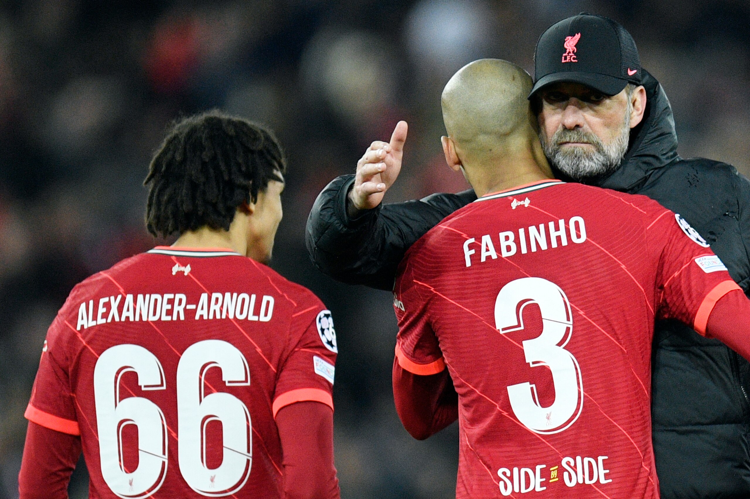 Liverpool's German manager Jurgen Klopp (R) congratulates Liverpool's Brazilian midfielder Fabinho (C) and Liverpool's English defender Trent Alexander-Arnold (L) at the end of the UEFA Champions League semi-final first leg football match between Liverpool and Villarreal, at the Anfield Stadium, in Liverpool, on April 27, 2022. - Liverpool beats Villarreal 2-0. (Photo by Oli SCARFF / AFP) (Photo by OLI SCARFF/AFP via Getty Images)