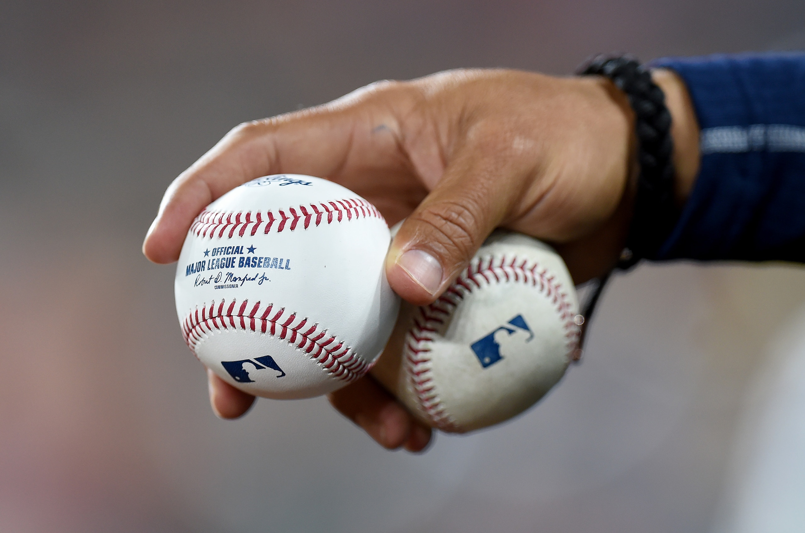 BALTIMORE, MARYLAND - APRIL 13: A Milwaukee Brewers player holds baseballs during the game against the Baltimore Orioles at Oriole Park at Camden Yards on April 13, 2022 in Baltimore, Maryland. (Photo by Greg Fiume/Getty Images)