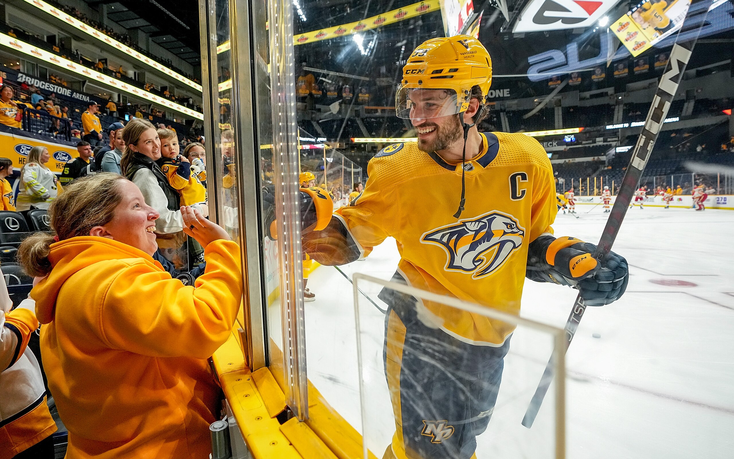 NASHVILLE, TN - APRIL 19: Roman Josi #59 of the Nashville Predators waves to a fan during warmups prior to an NHL game against the Calgary Flames at Bridgestone Arena on April 19, 2022 in Nashville, Tennessee. (Photo by John Russell/NHLI via Getty Images)