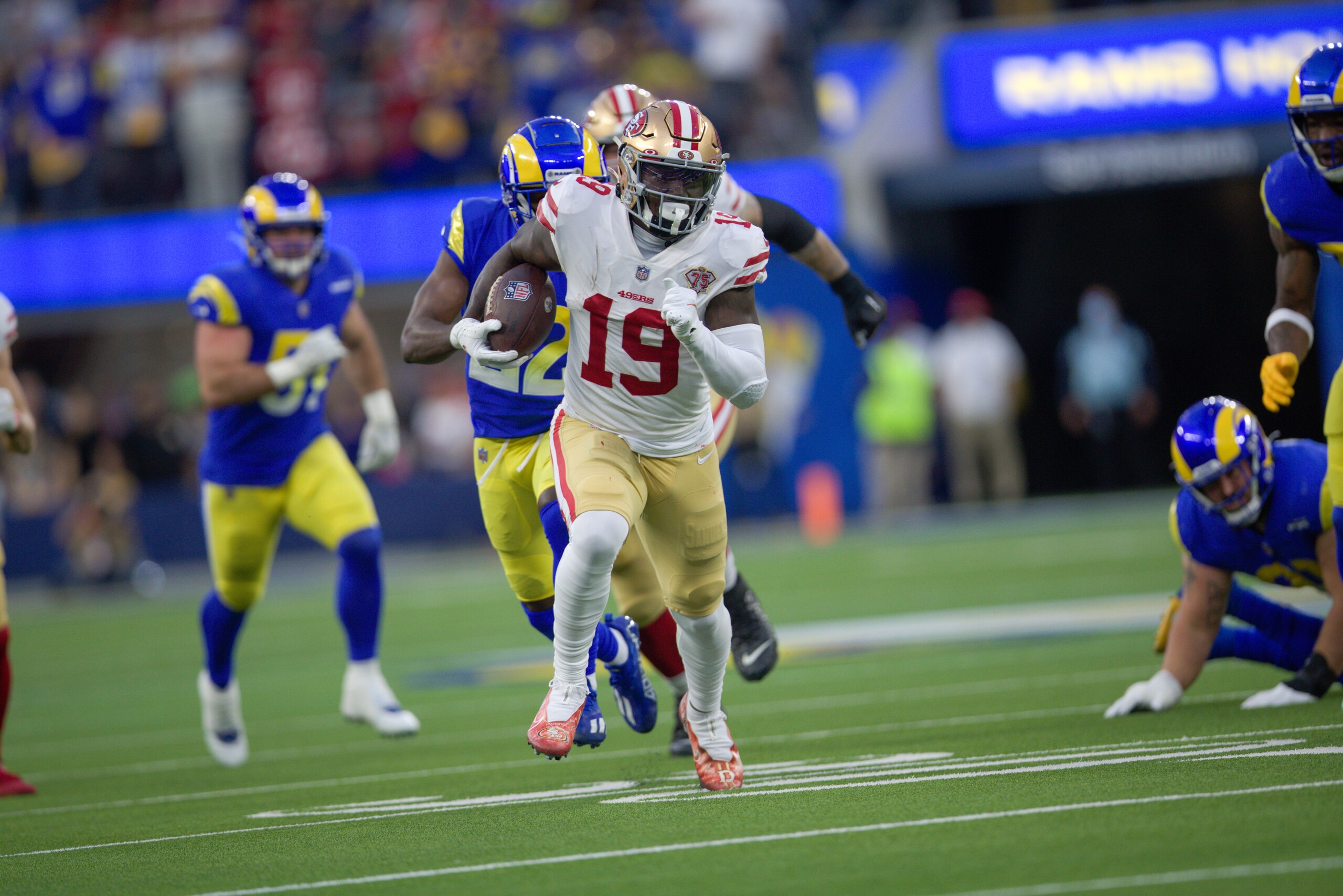 INGLEWOOD, CA - JANUARY 30: Deebo Samuel #19 of the San Francisco 49ers heads to the end zone on a 44-yard touchdown catch during the game against the Los Angeles Rams at SoFi Stadium on January 30, 2022 in Inglewood, California. The Rams defeated the 49ers 20-17. (Photo by Michael Zagaris/San Francisco 49ers/Getty Images) INGLEWOOD, CA - JANUARY 30: Deebo Samuel #19 of the San Francisco 49ers heads to the end zone on a 44-yard touchdown catch during the game against the Los Angeles Rams at SoFi Stadium on January 30, 2022 in Inglewood, California. The Rams defeated the 49ers 20-17. (Photo by Michael Zagaris/San Francisco 49ers/Getty Images)