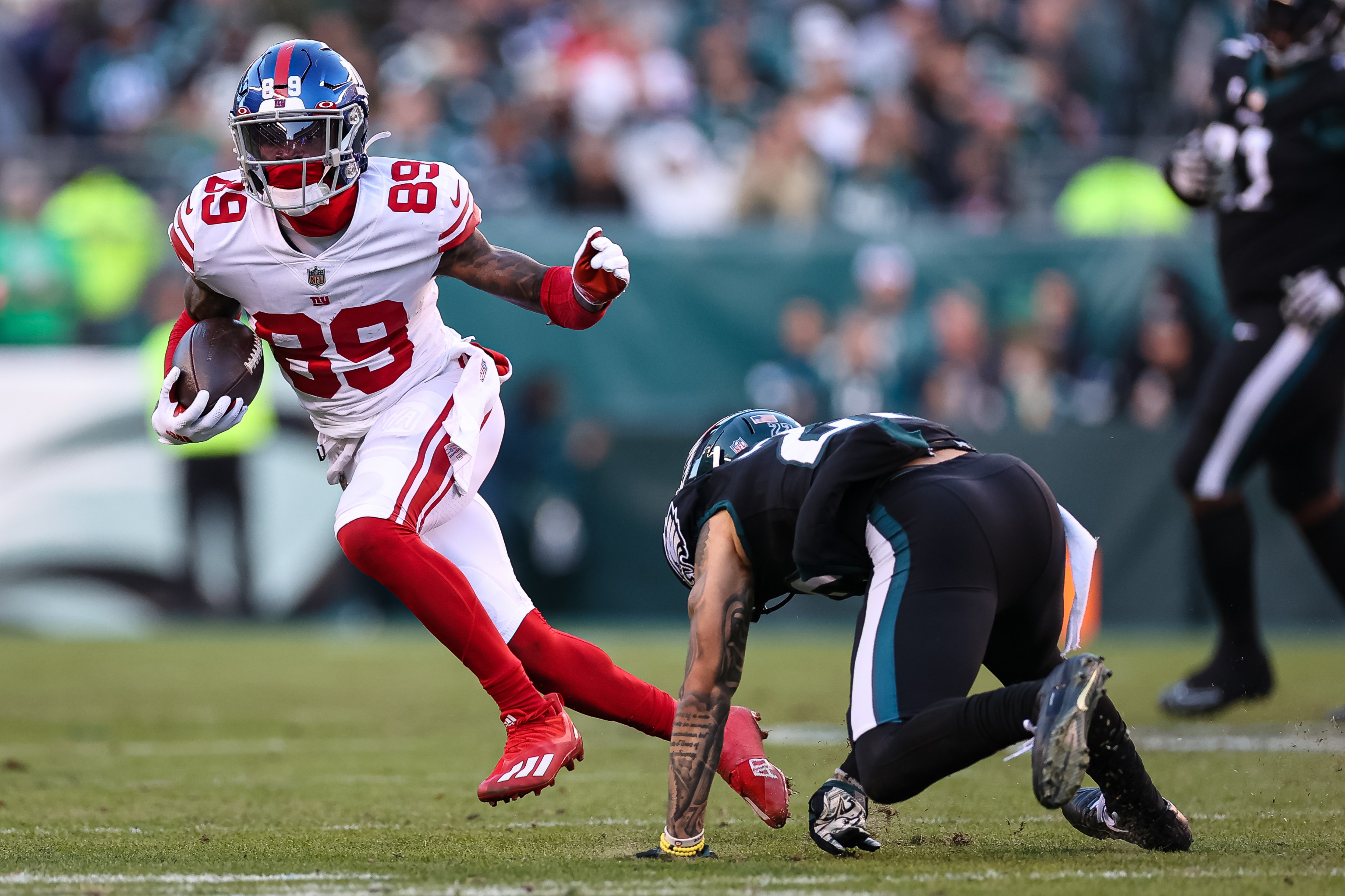 PHILADELPHIA, PA - DECEMBER 26: Kadarius Toney #89 of the New York Giants carries the ball against Marcus Epps #22 of the Philadelphia Eagles during the second half at Lincoln Financial Field on December 26, 2021 in Philadelphia, Pennsylvania. (Photo by Scott Taetsch/Getty Images) No licensing by any casino, sportsbook, and/or fantasy sports organization for any purpose. During game play, no use of images within play-by-play, statistical account or depiction of a game (e.g., limited to use of fewer than 10 images during the game).