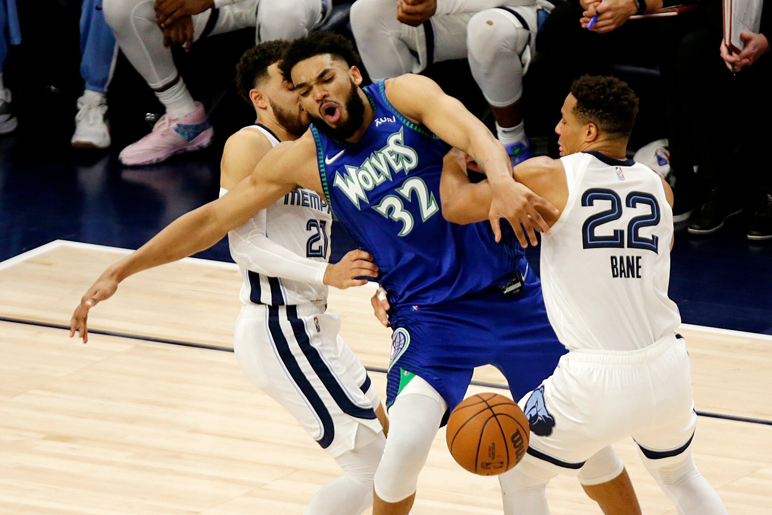 Minnesota Timberwolves center Karl-Anthony Towns (32) is fouled by Memphis Grizzlies guard Desmond Bane (22) with defensive help from Grizzlies guard Tyus Jones (21) in the first half in Game 6 of an NBA basketball first-round playoff series Friday, April 29, 2022, in Minneapolis. (AP Photo/Andy Clayton-King)