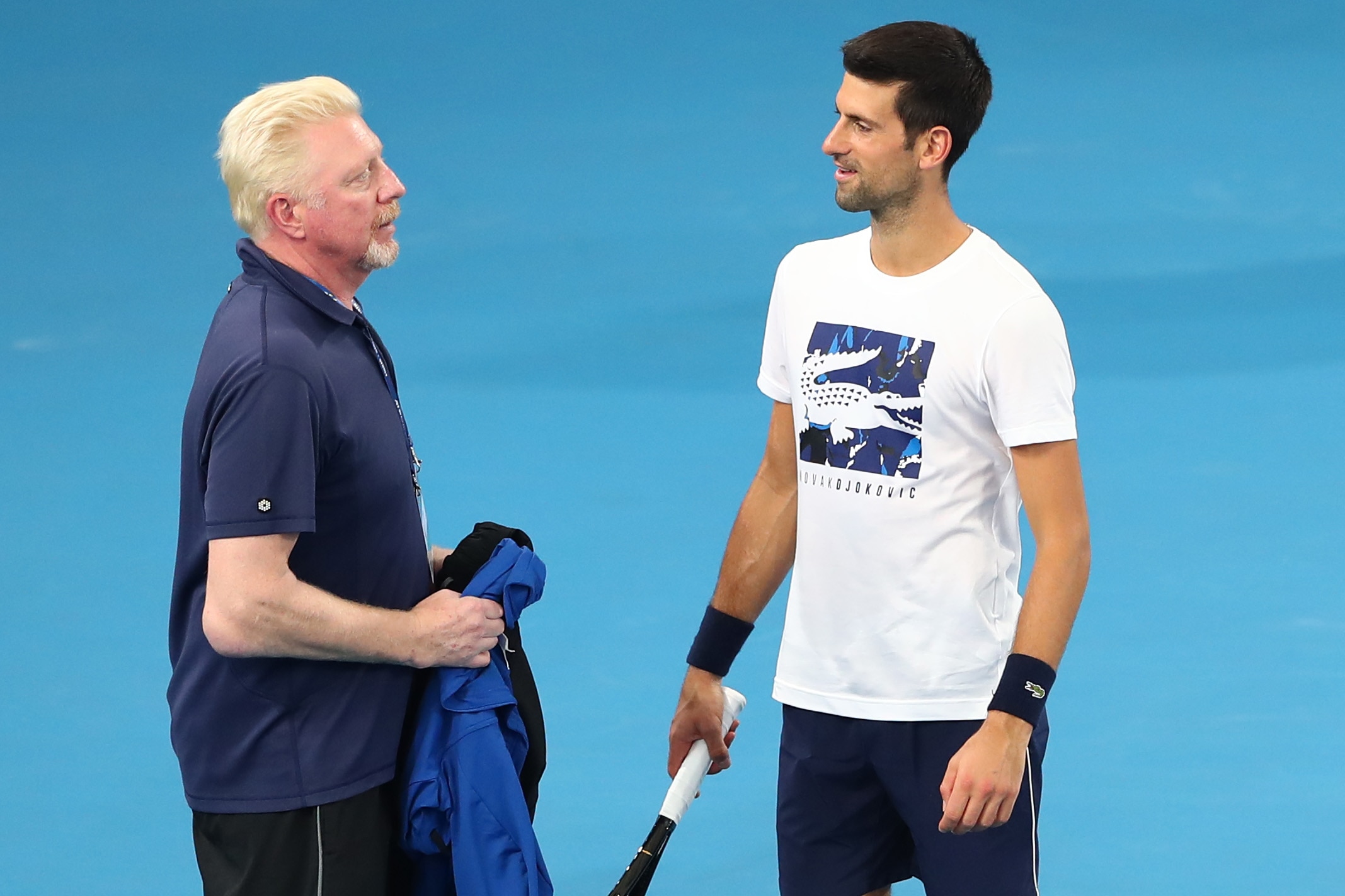 BRISBANE, AUSTRALIA - JANUARY 02: Boris Becker and Novak Djokovic of Serbia talk during a practice session ahead of the 2020 ATP Cup Group Stage at Pat Rafter Arena on January 02, 2020 in Brisbane, Australia. (Photo by Chris Hyde/Getty Images)