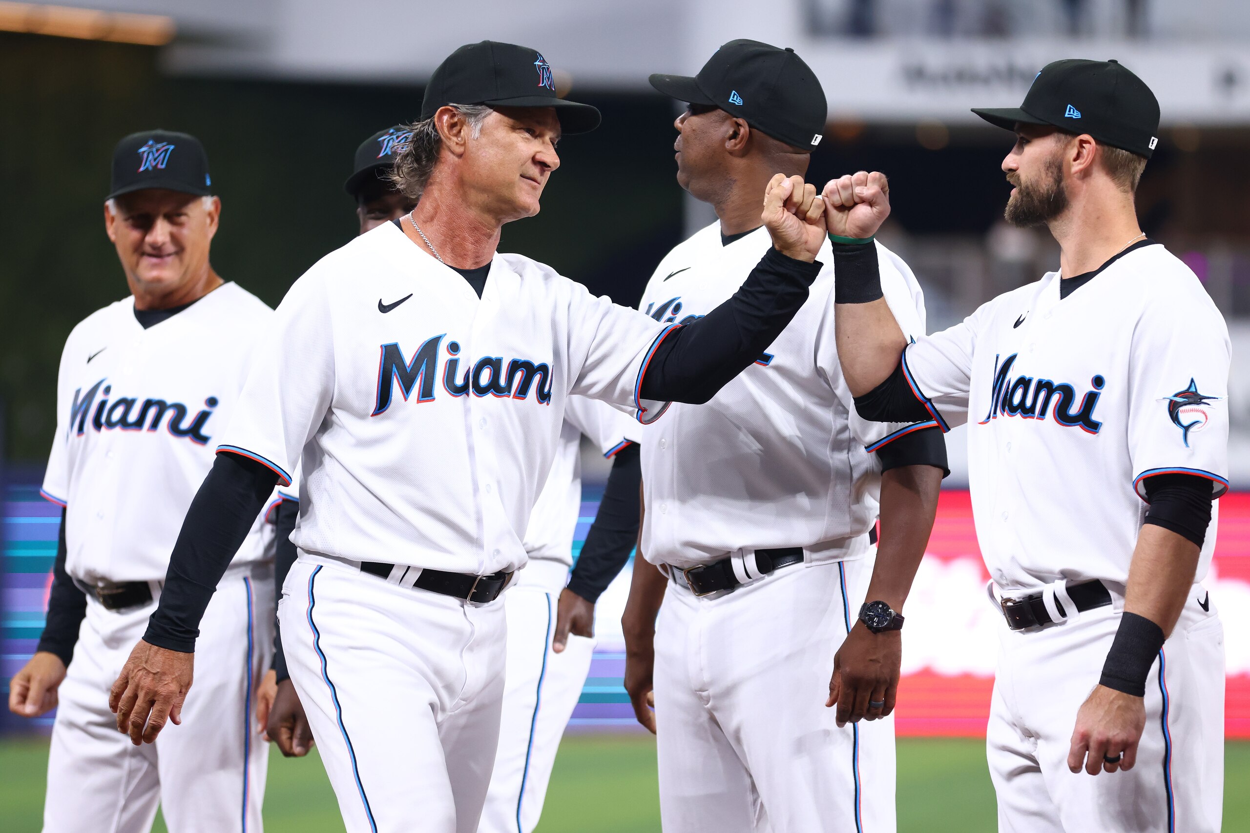 MIAMI, FLORIDA - APRIL 14: Manager Don Mattingly #8 of the Miami Marlins fist bumps Jon Berti #5 as he is introduced prior to the game against the Philadelphia Phillies at loanDepot park on April 14, 2022 in Miami, Florida. (Photo by Michael Reaves/Getty Images)
