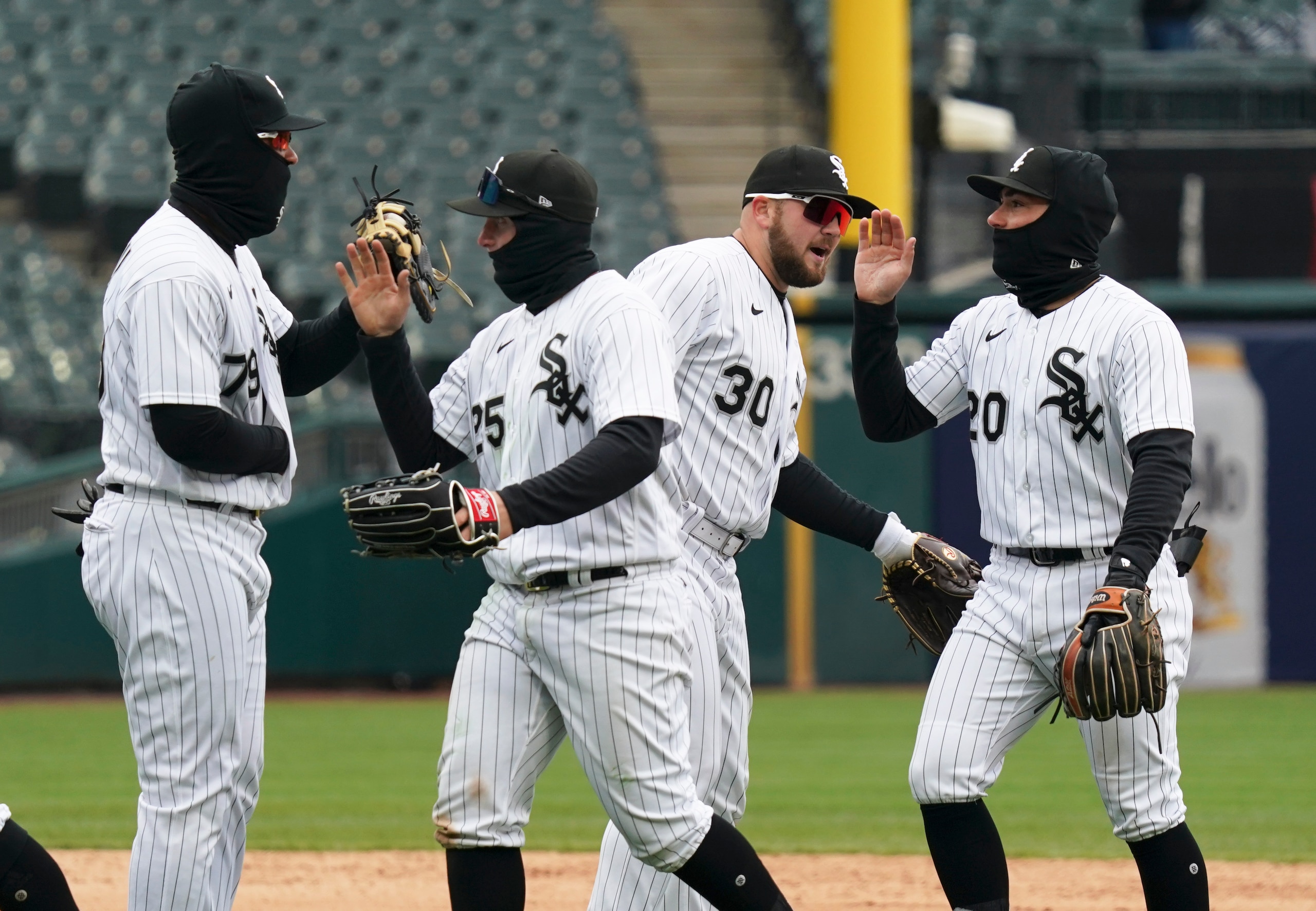 CHICAGO, ILLINOIS - APRIL 27: (L-R) Jose Abreu #79, Andrew Vaughn #25, Jake Burger #30, and Danny Mendick #20 of the Chicago White Sox celebrate their team win over the Kansas City Royals at Guaranteed Rate Field on April 27, 2022 in Chicago, Illinois. The White Sox defeated the Royals 7-3. (Photo by Nuccio DiNuzzo/Getty Images)