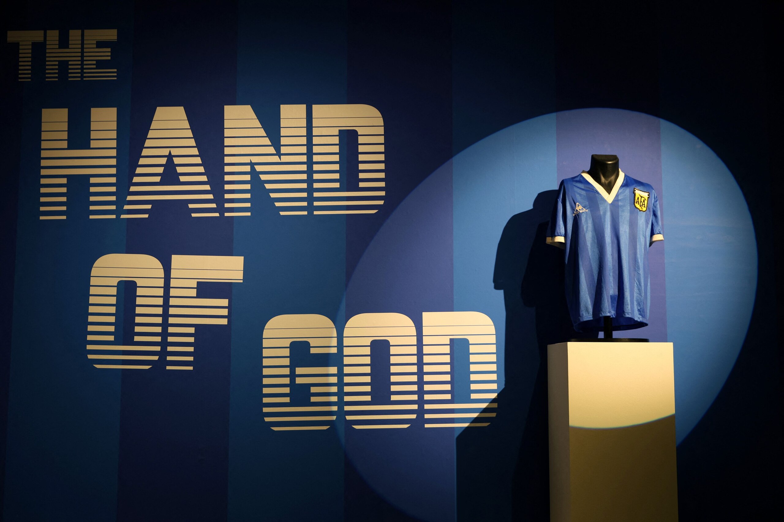A football shirt worn by Argentina's Diego Maradona during the 1986 World Cup quarter-final match against England, is pictured during a photocall at Sotheby's auction house in London on April 20, 2022, ahead of its sale. - The jersey worn by Diego Maradona when he scored twice against England in the 1986 World Cup, including the infamous "hand of God" goal, is to be auctioned off this month, Sotheby's announced Wednesday. The blue number 10 shirt has been owned since the end of the controversial World Cup encounter by opposing midfielder Steve Hodge, who swapped his jersey with Maradona after England lost 2-1. (Photo by ADRIAN DENNIS / AFP) (Photo by ADRIAN DENNIS/AFP via Getty Images) A football shirt worn by Argentina's Diego Maradona during the 1986 World Cup quarter-final match against England, is pictured during a photocall at Sotheby's auction house in London on April 20, 2022, ahead of its sale. - The jersey worn by Diego Maradona when he scored twice against England in the 1986 World Cup, including the infamous "hand of God" goal, is to be auctioned off this month, Sotheby's announced Wednesday. The blue number 10 shirt has been owned since the end of the controversial World Cup encounter by opposing midfielder Steve Hodge, who swapped his jersey with Maradona after England lost 2-1. (Photo by ADRIAN DENNIS / AFP) (Photo by ADRIAN DENNIS/AFP via Getty Images)