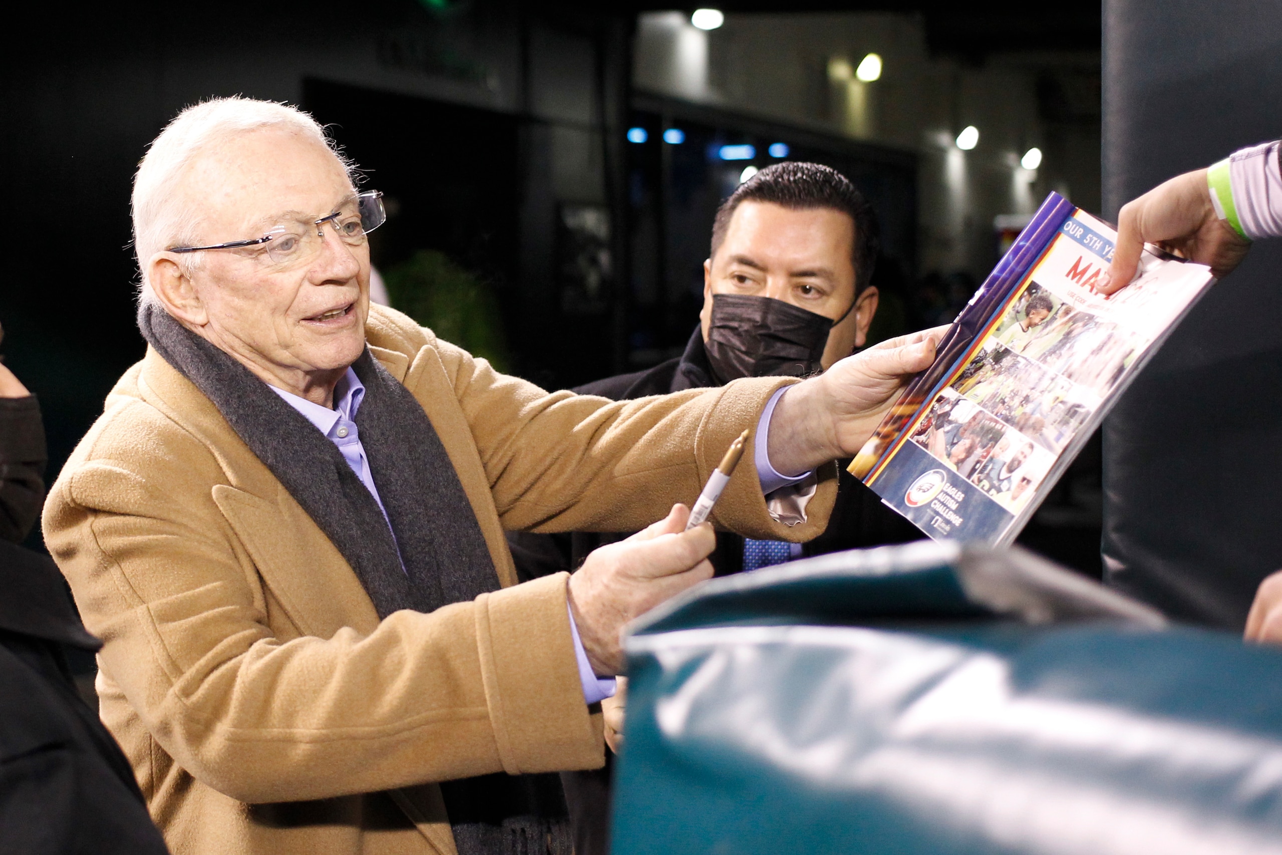 Dallas Cowboys owner Jerry Jones signs autographs before an NFL football game against the Philadelphia Eagles, Saturday, Jan. 8, 2022, in Philadelphia. (AP Photo/Laurence Kesterson)