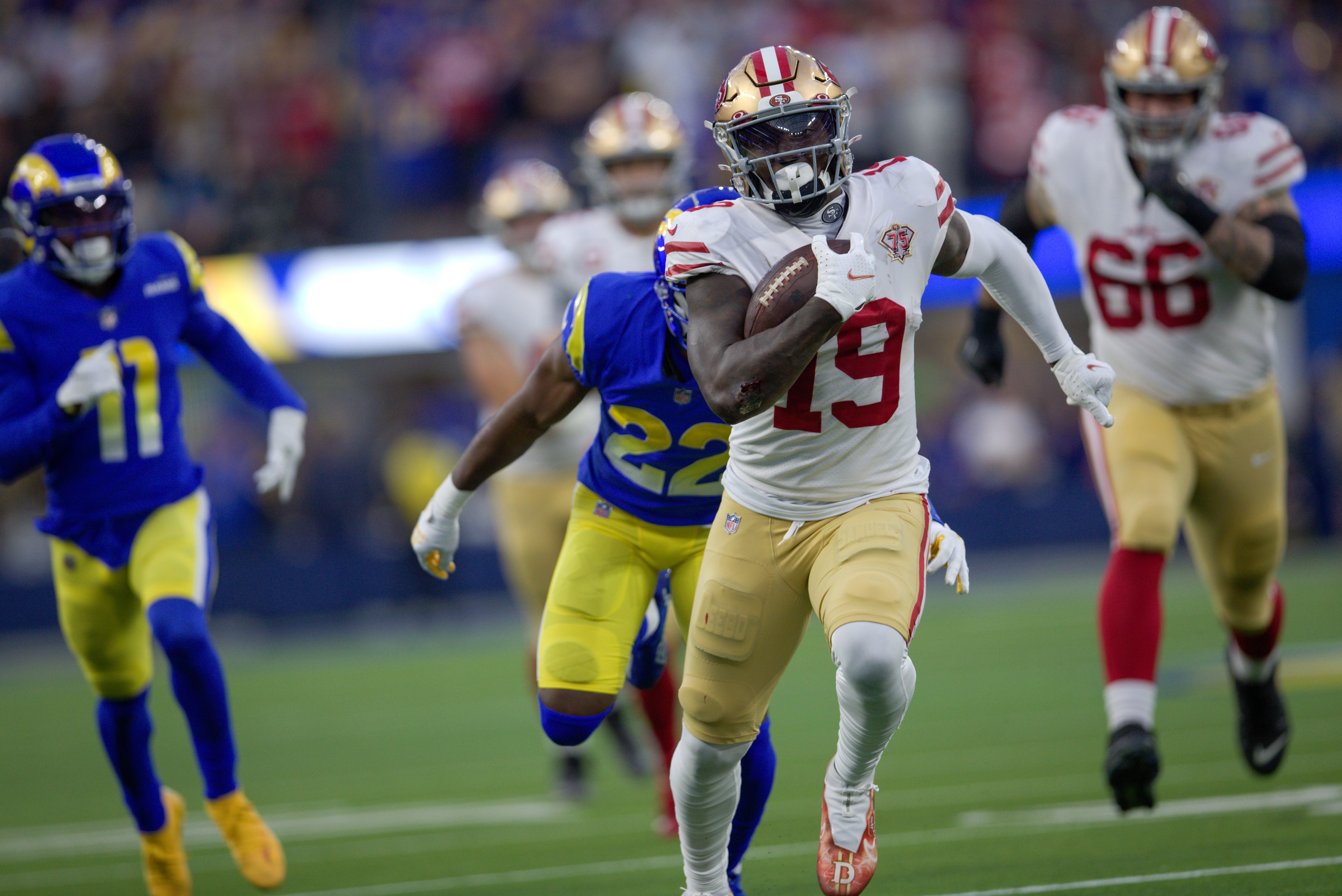 INGLEWOOD, CA - JANUARY 30: Deebo Samuel #19 of the San Francisco 49ers heads to the end zone on a 44-yard touchdown catch during the game against the Los Angeles Rams at SoFi Stadium on January 30, 2022 in Inglewood, California. The Rams defeated the 49ers 20-17. (Photo by Michael Zagaris/San Francisco 49ers/Getty Images)