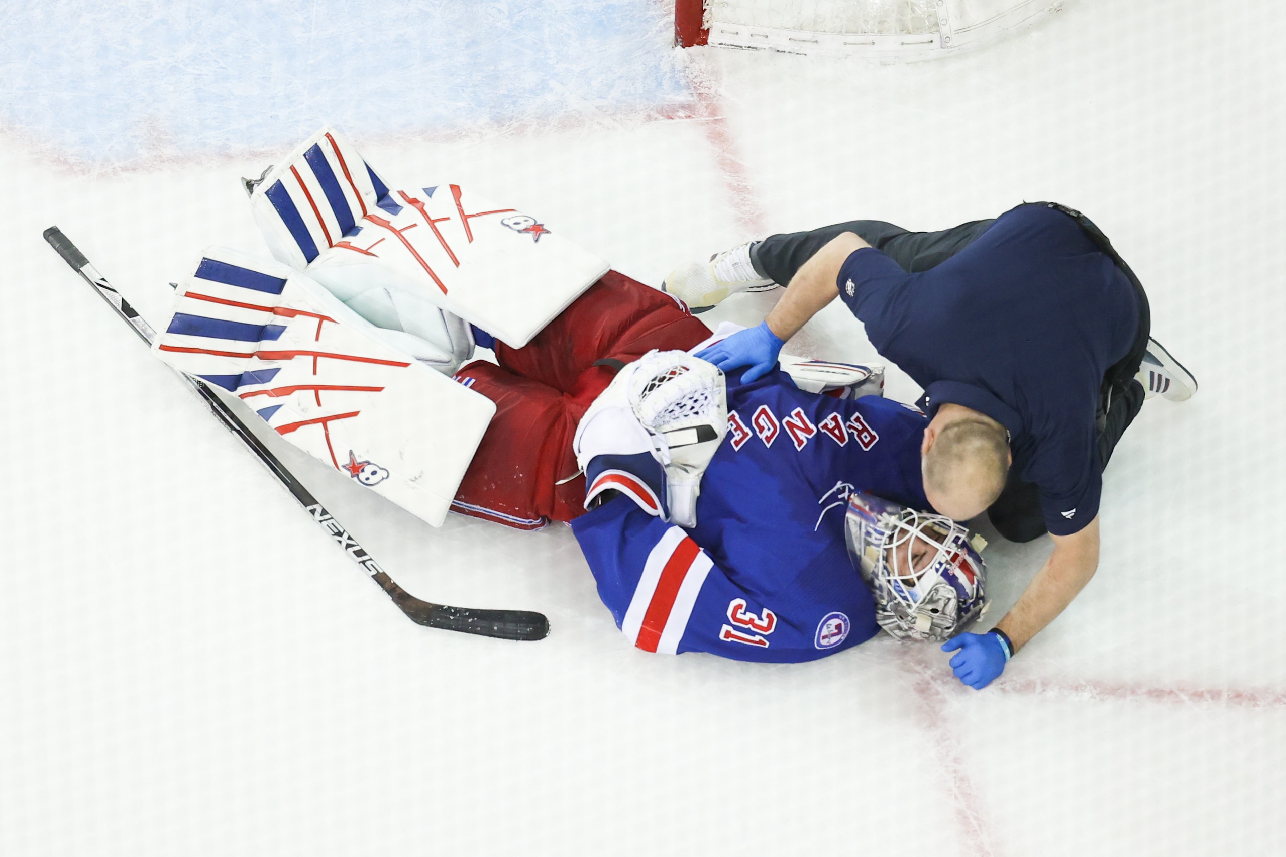 NEW YORK, NY - MAY 05: New York Rangers Goaltender Igor Shesterkin (31) iOS examined by medical staffed after being hit by Pittsburgh Penguins Center Jeff Carter (77) during the third period of game 2 of the first round of the NHL Stanley Cup Playoffs between the Pittsburgh Penguins and the New York Rangers on May 5, 2022 at Madison Square Garden in New York, NY. (Photo by Joshua Sarner/Icon Sportswire via Getty Images)