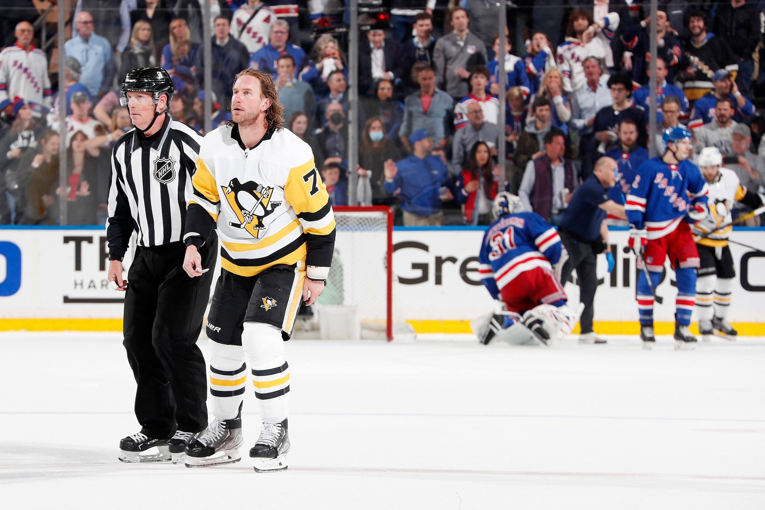 NEW YORK, NEW YORK - MAY 05: Jeff Carter #77 of the Pittsburgh Penguins is escorted after hitting Igor Shesterkin #31 of the New York Rangers in the third period in Game Two of the First Round of the 2022 Stanley Cup Playoffs at Madison Square Garden on May 05, 2022 in New York City. (Photo by Jared Silber/NHLI via Getty Images)