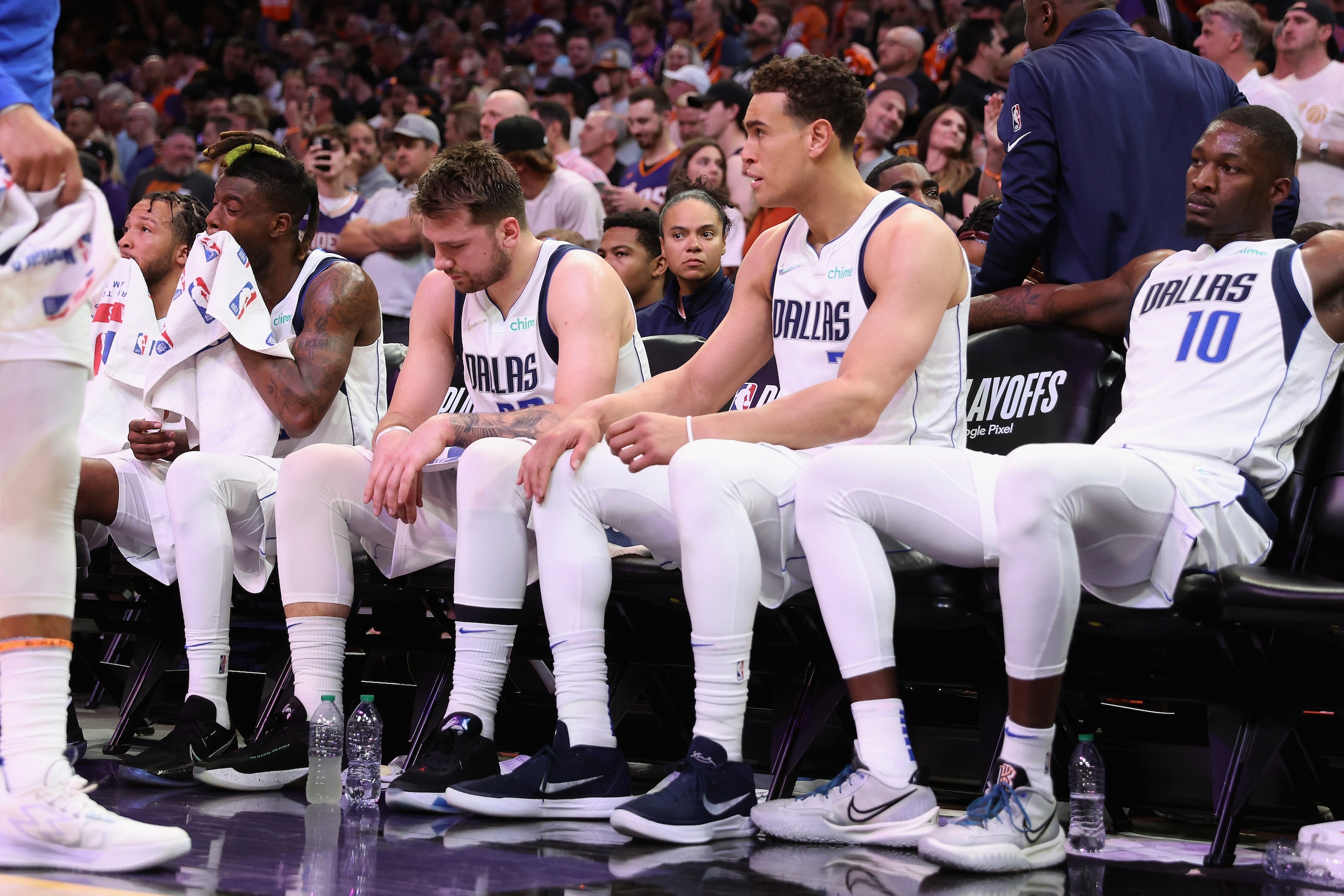 PHOENIX, ARIZONA - MAY 04: (L-R) Reggie Bullock #25, Luka Doncic #77, Dwight Powell #7 and Dorian Finney-Smith #10 of the Dallas Mavericks react on the bench during the second half of Game Two of the Western Conference Second Round NBA Playoffs at Footprint Center on May 04, 2022 in Phoenix, Arizona.  The Suns defeated the Mavericks 129-109. NOTE TO USER: User expressly acknowledges and agrees that, by downloading and or using this photograph, User is consenting to the terms and conditions of the Getty Images License Agreement. (Photo by Christian Petersen/Getty Images)
