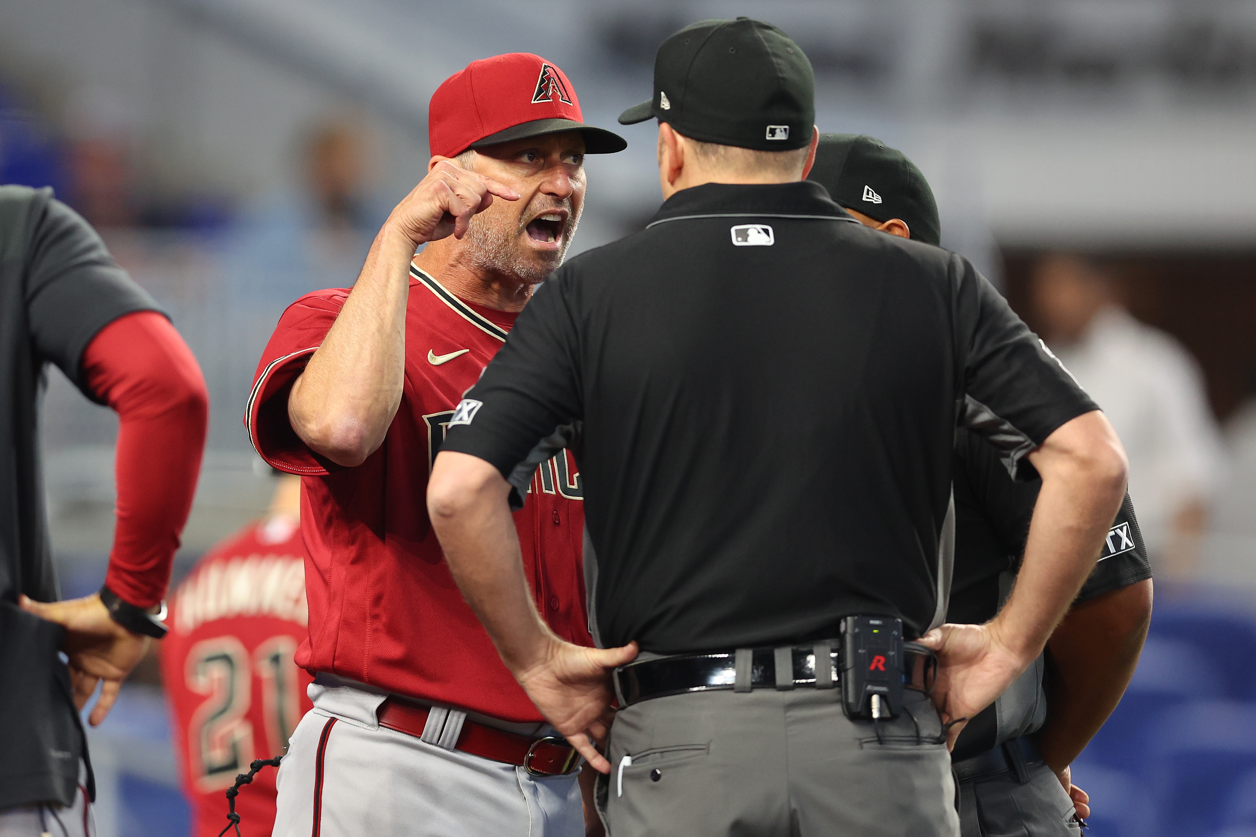 MIAMI, FLORIDA - MAY 04: Manager Torey Lovullo #17 of the Arizona Diamondbacks argues with umpires Dan Bellino #2 and Adrian Johnson #80 after Madison Bumgarner #40 (not pictured) was ejected from the game during the first inning against the Miami Marlins at loanDepot park on May 04, 2022 in Miami, Florida. (Photo by Michael Reaves/Getty Images)