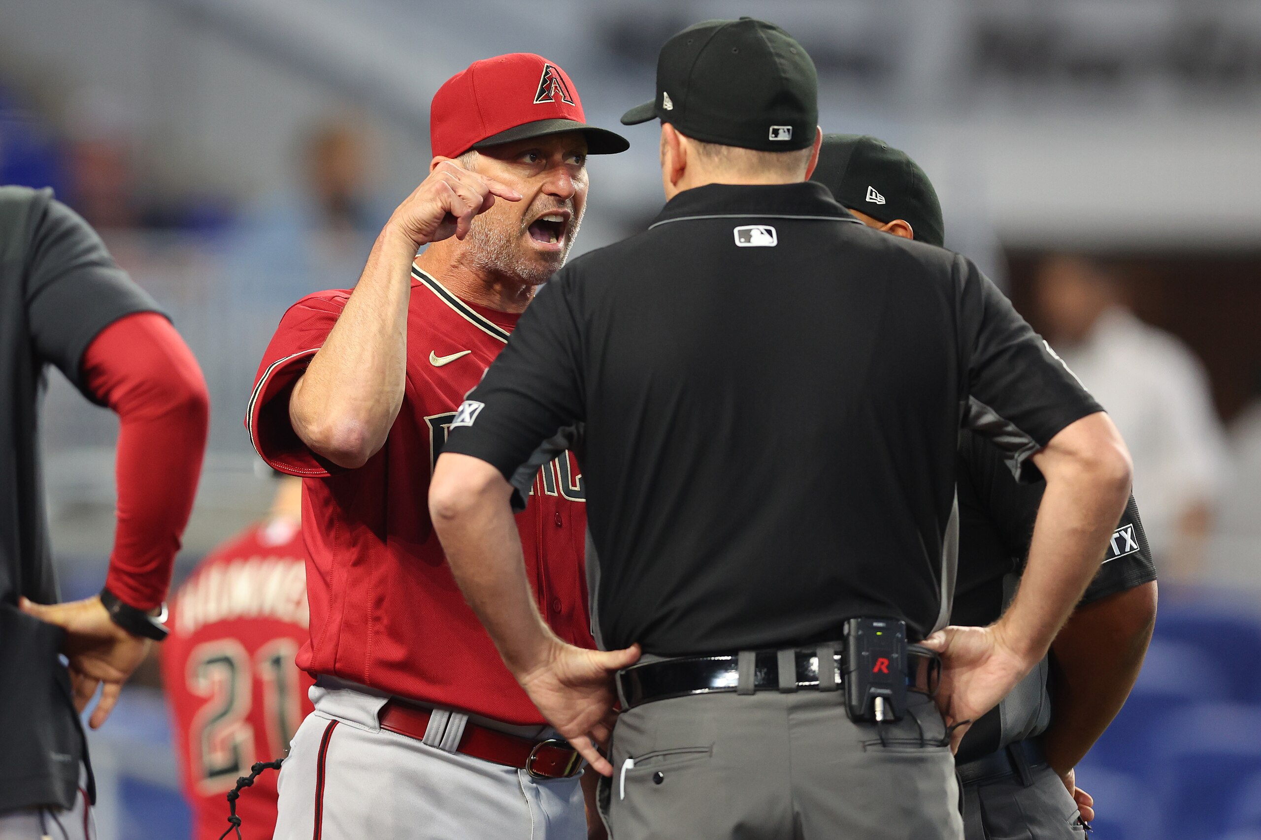 MIAMI, FLORIDA - MAY 04: Manager Torey Lovullo #17 of the Arizona Diamondbacks argues with umpires Dan Bellino #2 and Adrian Johnson #80 after Madison Bumgarner #40 (not pictured) was ejected from the game during the first inning against the Miami Marlins at loanDepot park on May 04, 2022 in Miami, Florida. (Photo by Michael Reaves/Getty Images)