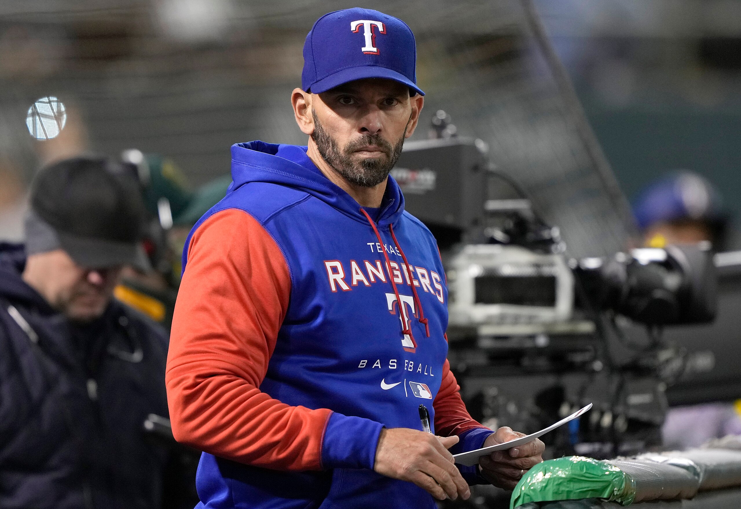 OAKLAND, CALIFORNIA - APRIL 22: Manager Chris Woodward #8 of the Texas Rangers looks on from the dugout against the Oakland Athletics in the bottom of the eighth inning at RingCentral Coliseum on April 22, 2022 in Oakland, California. (Photo by Thearon W. Henderson/Getty Images)