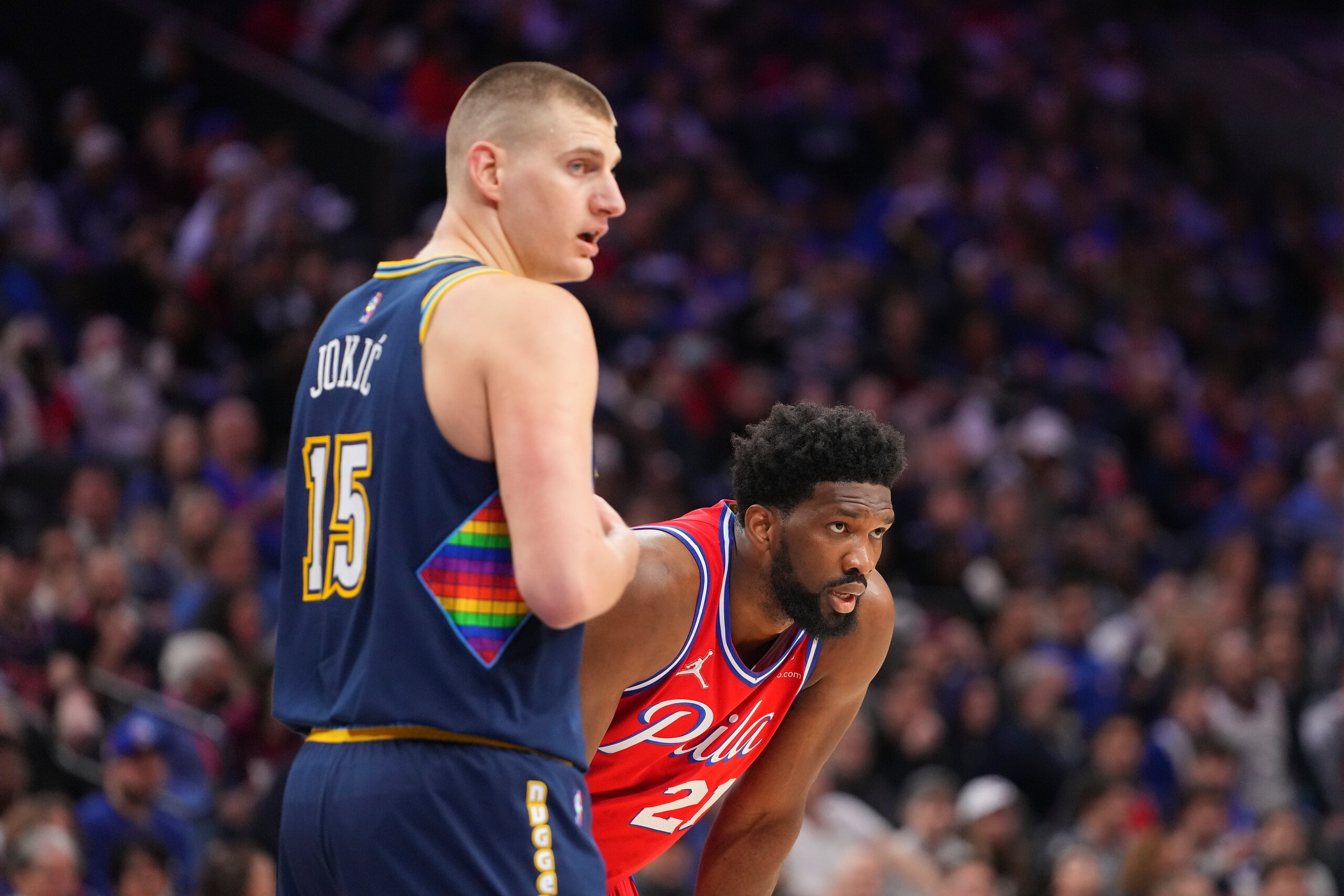 PHILADELPHIA, PA - MARCH 14: Nikola Jokic #15 of the Denver Nuggets guards Joel Embiid #21 of the Philadelphia 76ers in the first half at the Wells Fargo Center on March 14, 2022 in Philadelphia, Pennsylvania. NOTE TO USER: User expressly acknowledges and agrees that, by downloading and or using this photograph, User is consenting to the terms and conditions of the Getty Images License Agreement. (Photo by Mitchell Leff/Getty Images)