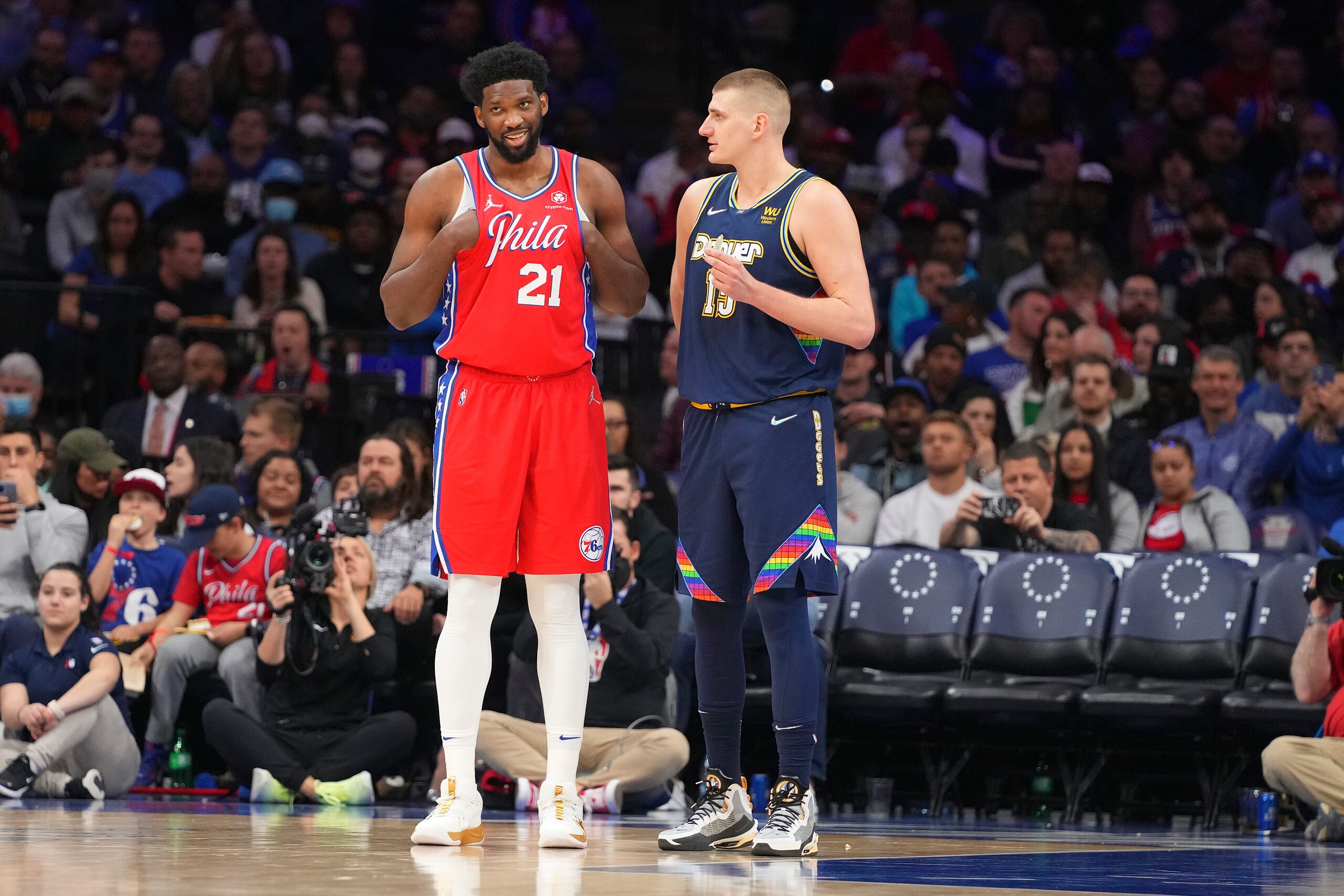 PHILADELPHIA, PA - MARCH 14: Joel Embiid #21 of the Philadelphia 76ers talks to Nikola Jokic #15 of the Denver Nuggets at the Wells Fargo Center on March 14, 2022 in Philadelphia, Pennsylvania. The Nuggets defeated the 76ers 114-110. NOTE TO USER: User expressly acknowledges and agrees that, by downloading and or using this photograph, User is consenting to the terms and conditions of the Getty Images License Agreement. (Photo by Mitchell Leff/Getty Images)