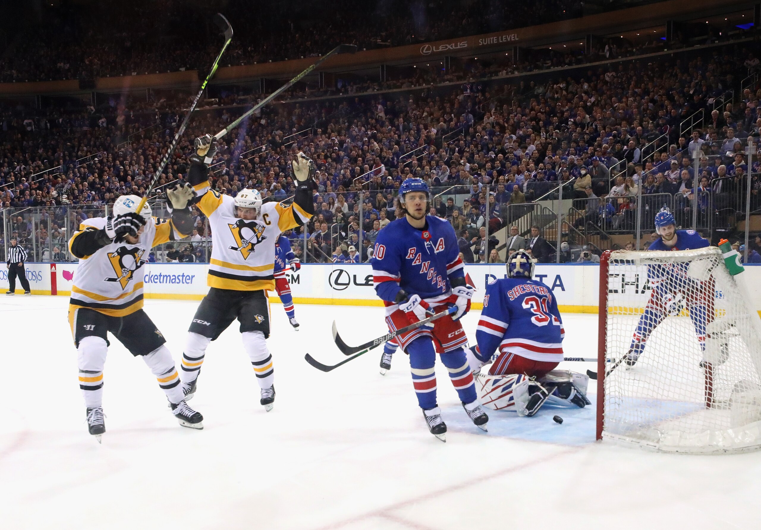 NEW YORK, NEW YORK - MAY 05: Sidney Crosby #87 of the Pittsburgh Penguins (2nd from left) celebrates his second period goal against Igor Shesterkin #31 of the New York Rangers in Game Two of the First Round of the 2022 Stanley Cup Playoffs at Madison Square Garden on May 05, 2022 in New York City. The Rangers defeated the Penguins 5-2. (Photo by Bruce Bennett/Getty Images)