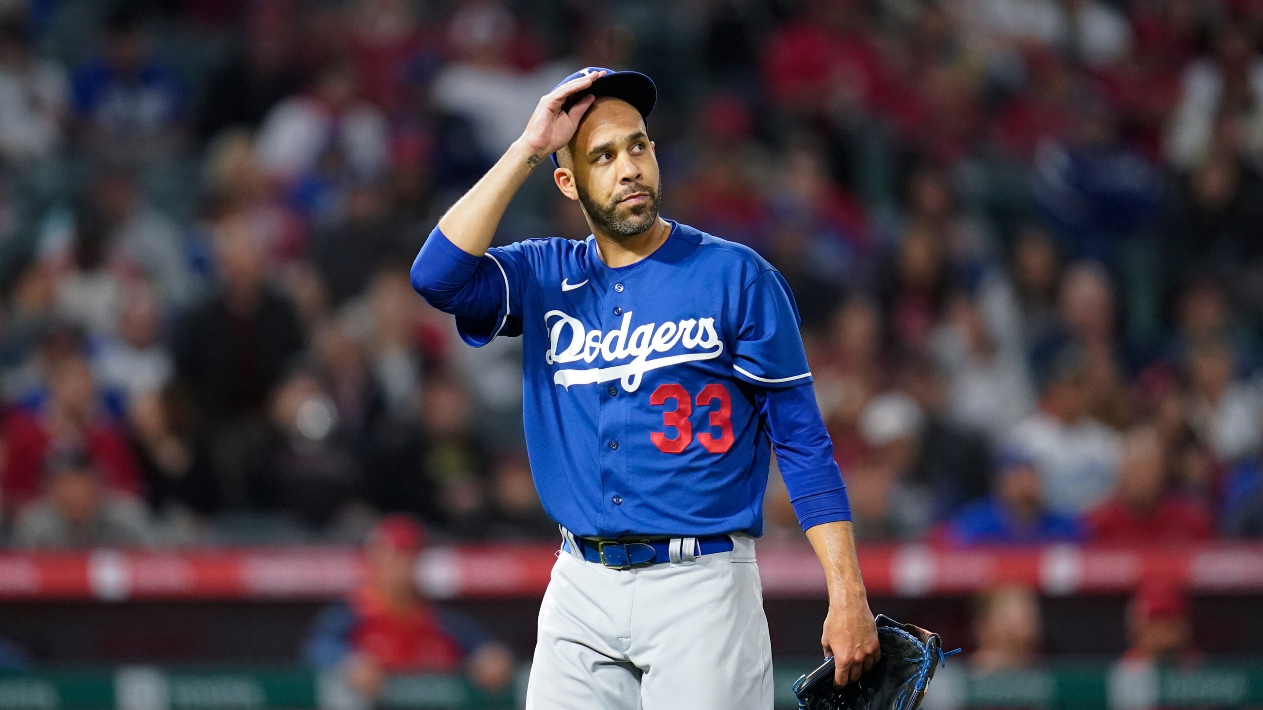 Los Angeles Dodgers' David Price (33) returns to the dugout during a spring training baseball game against the Los Angeles Angels in Anaheim, Calif., Monday, April 4, 2022. (AP Photo/Ashley Landis)