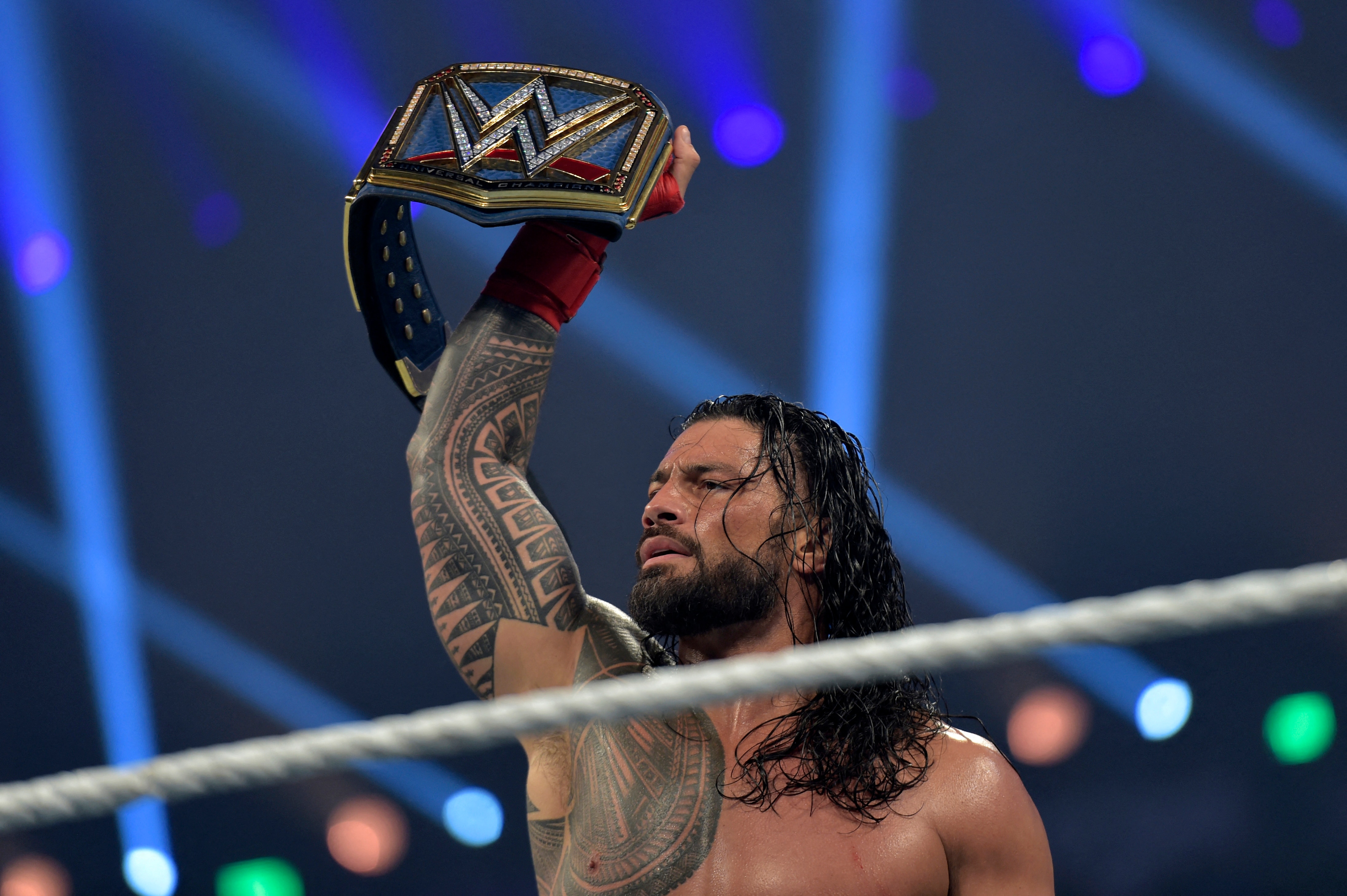 Roman Reigns celebrates after defeating Bill Goldberg during the 2022 WWE Elimination Chamber at the Jeddah Super Dome in Saudi Arabia's Red Sea coastal city of Jeddah on February 19, 2022. (Photo by Amer HILABI / AFP) (Photo by AMER HILABI/AFP via Getty Images)