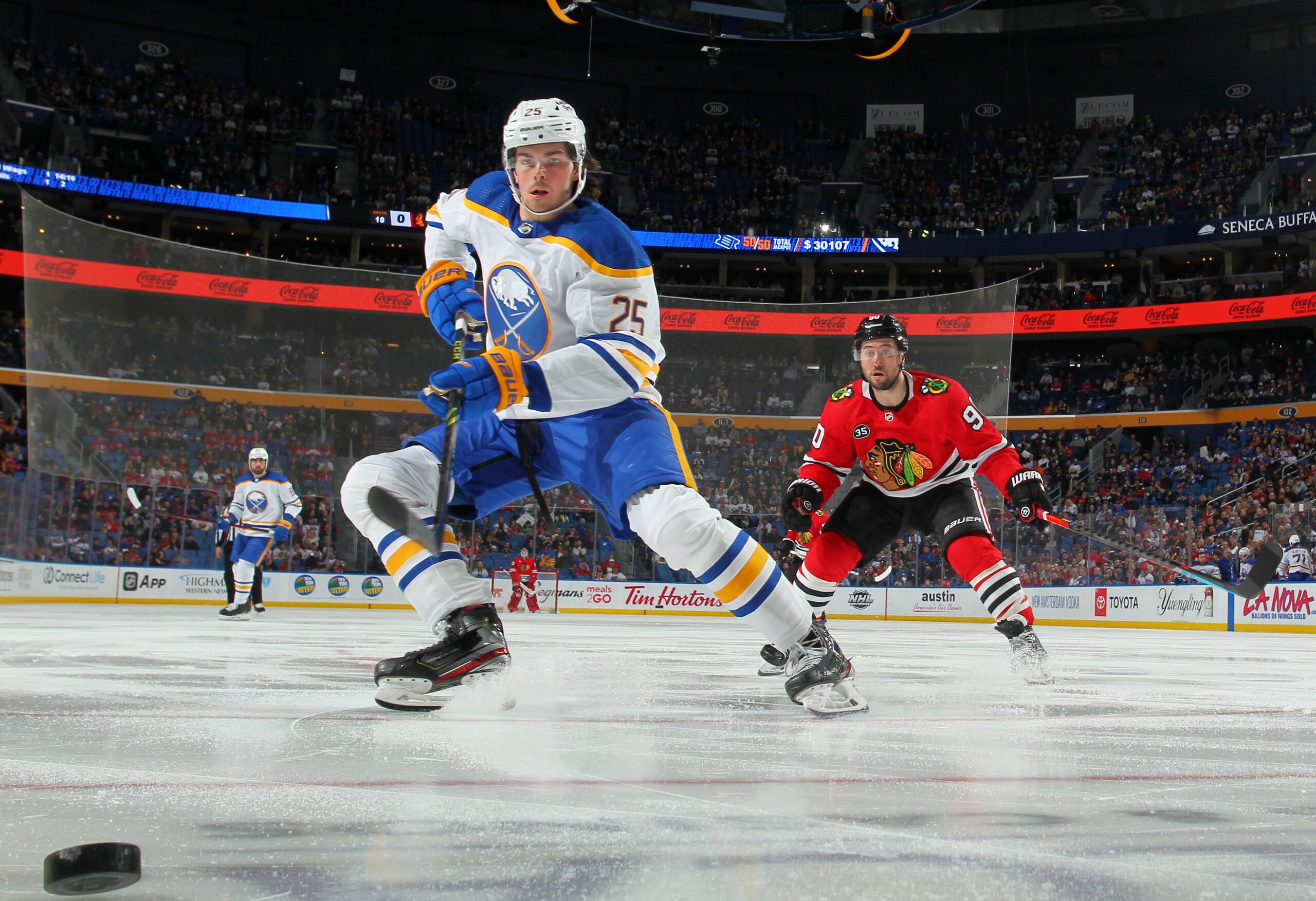 BUFFALO, NY - APRIL 29: Owen Power #25 of the Buffalo Sabres looks to control the puck against Tyler Johnson #90 of the Chicago Blackhawks during an NHL game on April 29, 2022 at KeyBank Center in Buffalo, New York. (Photo by Bill Wippert/NHLI via Getty Images) BUFFALO, NY - APRIL 29: Owen Power #25 of the Buffalo Sabres looks to control the puck against Tyler Johnson #90 of the Chicago Blackhawks during an NHL game on April 29, 2022 at KeyBank Center in Buffalo, New York. (Photo by Bill Wippert/NHLI via Getty Images)