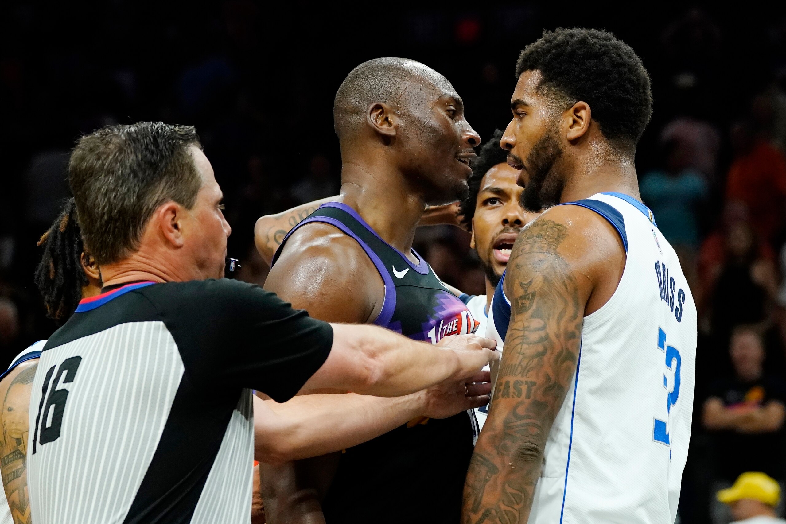 Referee David Guthrie (16) tries to separate Phoenix Suns center Bismack Biyombo, middle, and Dallas Mavericks forward Marquese Chriss, right, as Mavericks forward Sterling Brown, second from right, agrues during the second half of Game 5 of an NBA basketball second-round playoff series Tuesday, May 10, 2022, in Phoenix. The Suns won 110-80. (AP Photo/Ross D. Franklin) Referee David Guthrie (16) tries to separate Phoenix Suns center Bismack Biyombo, middle, and Dallas Mavericks forward Marquese Chriss, right, as Mavericks forward Sterling Brown, second from right, agrues during the second half of Game 5 of an NBA basketball second-round playoff series Tuesday, May 10, 2022, in Phoenix. The Suns won 110-80. (AP Photo/Ross D. Franklin)