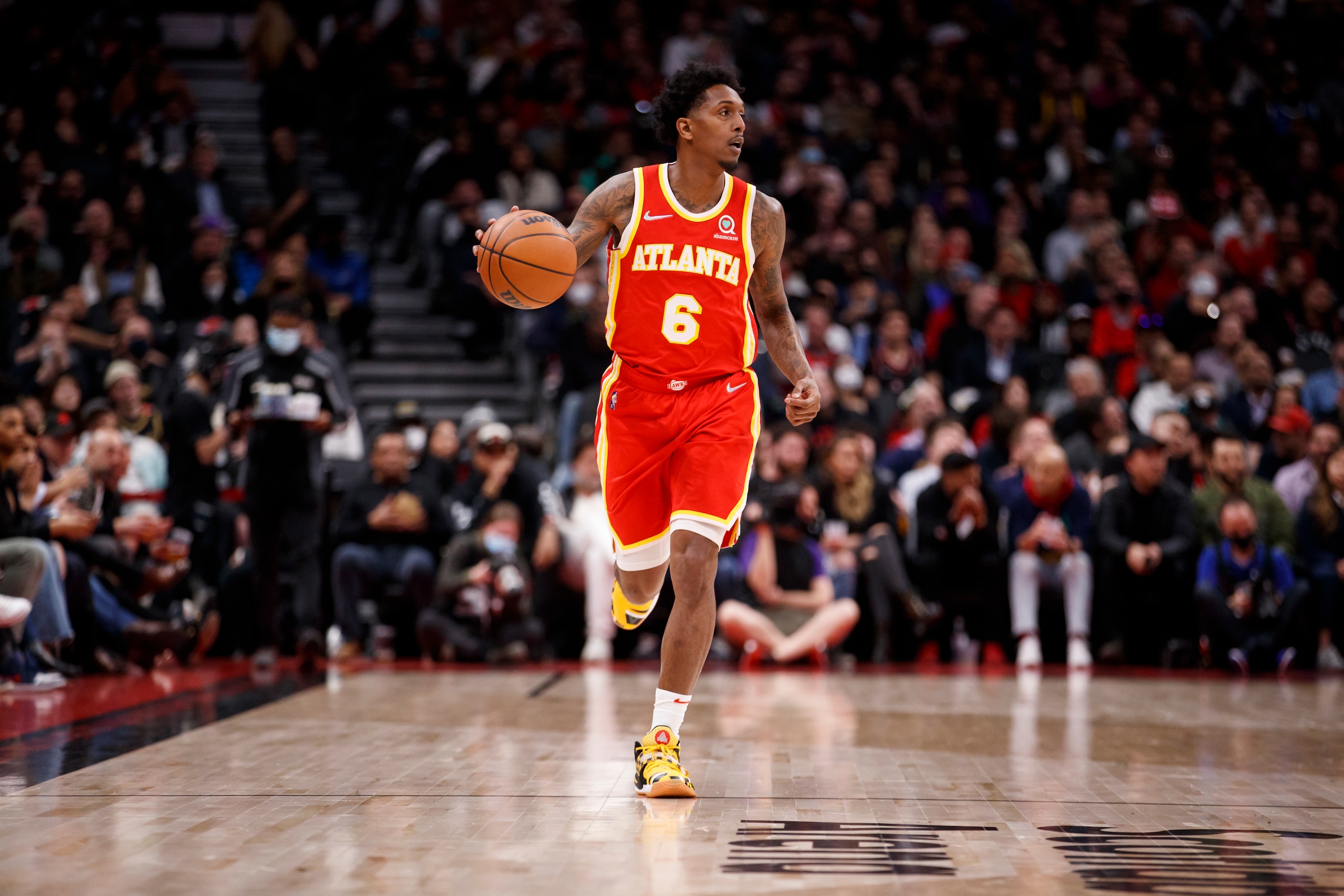 TORONTO, ON - APRIL 05: Lou Williams #6 of the Atlanta Hawks dribbles up court during the first half of their NBA game at Scotiabank Arena on April 5, 2022 in Toronto, Canada. NOTE TO USER: User expressly acknowledges and agrees that, by downloading and or using this Photograph, user is consenting to the terms and conditions of the Getty Images License Agreement. (Photo by Cole Burston/Getty Images)