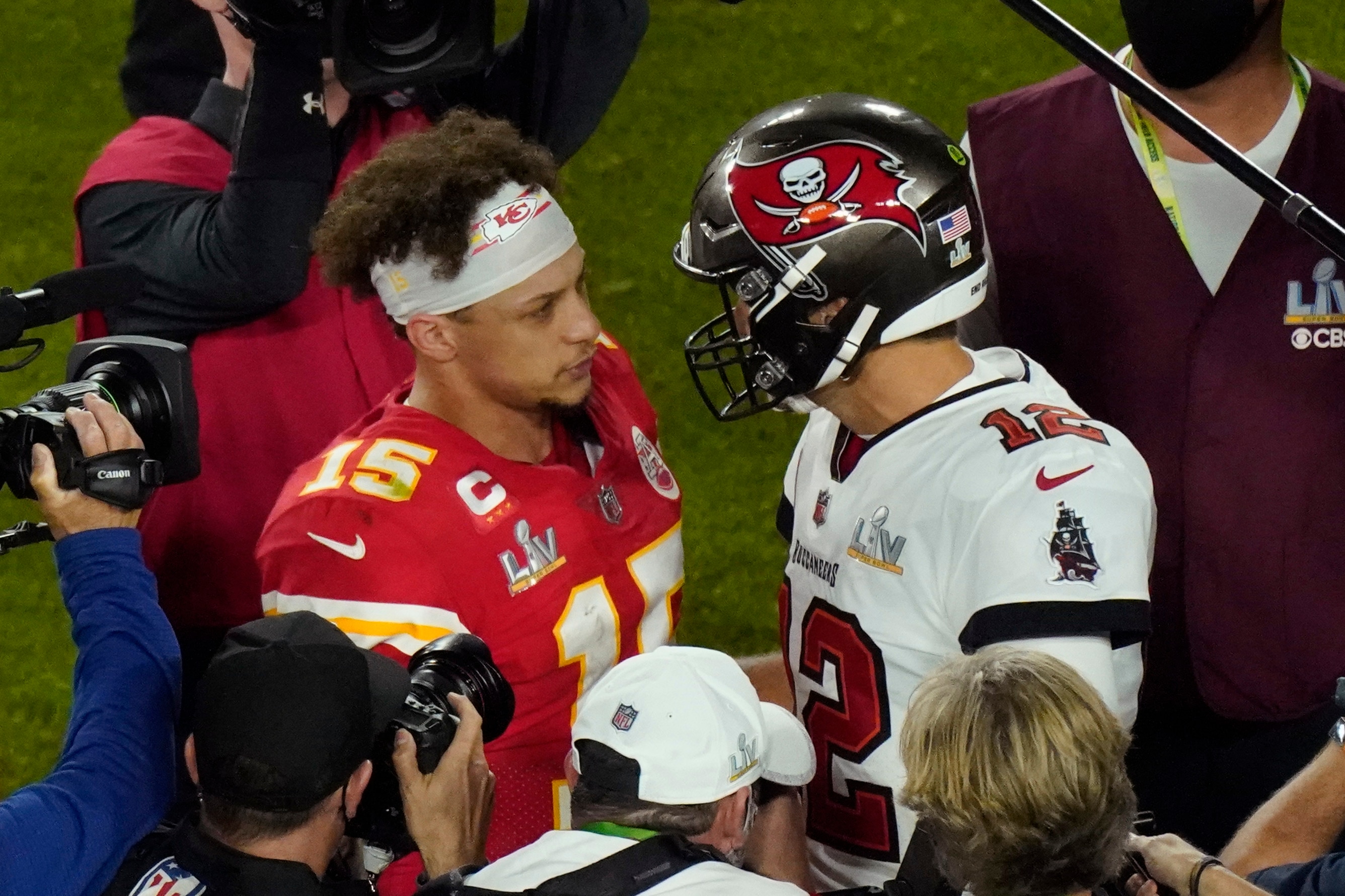 Kansas City Chiefs quarterback Patrick Mahomes (15) and Tampa Bay Buccaneers quarterback Tom Brady (12) greet following the NFL Super Bowl 55 football game Sunday, Feb. 7, 2021, in Tampa, Fla. Tampa Bay won 31-9. (AP Photo/Charlie Riedel)