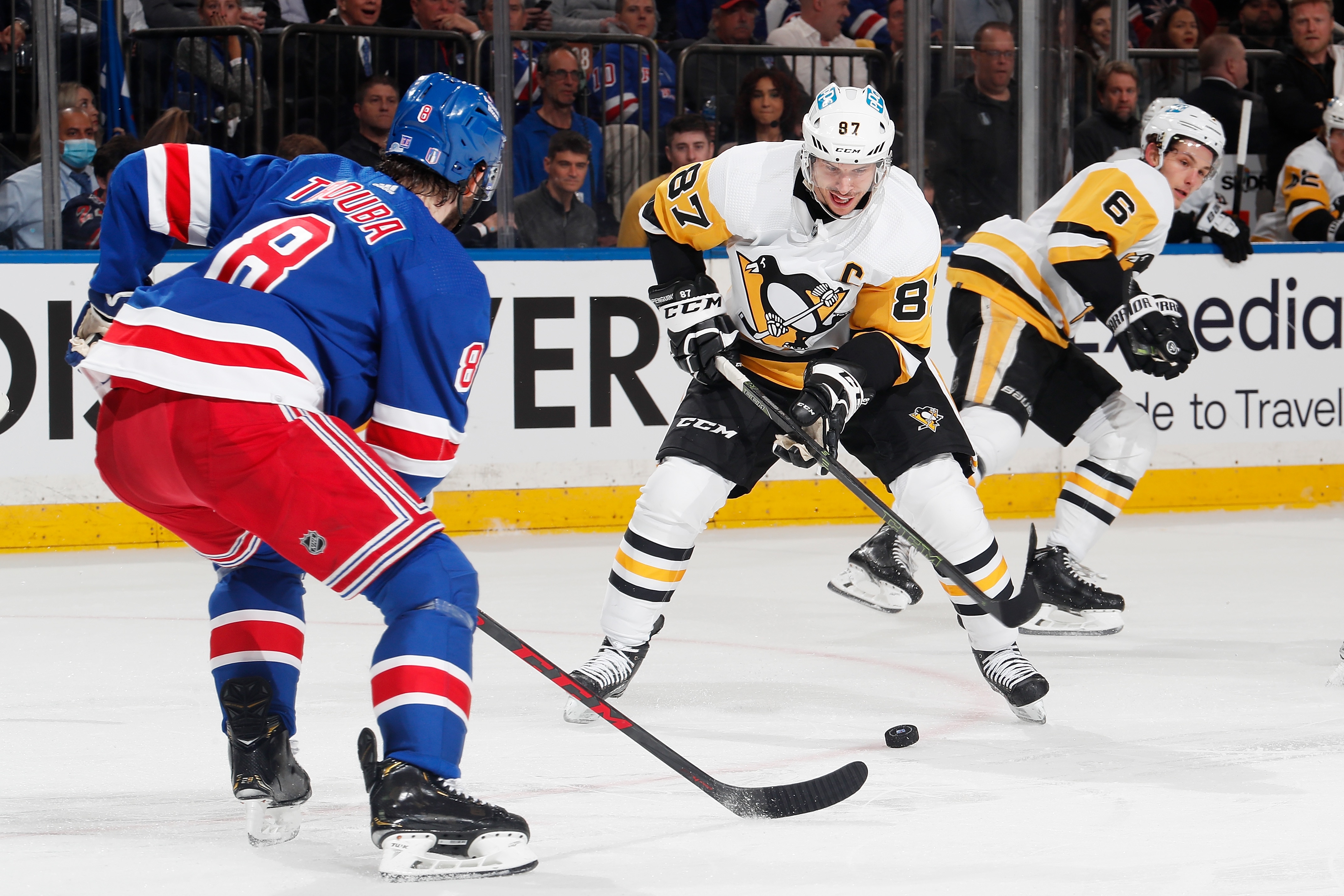 NEW YORK, NEW YORK - MAY 11: Sidney Crosby #87 of the Pittsburgh Penguins play the puck against Jacob Trouba #8 of the New York Rangers in Game Five of the First Round of the 2022 Stanley Cup Playoffs at Madison Square Garden on May 11, 2022 in New York City. (Photo by Jared Silber/NHLI via Getty Images)