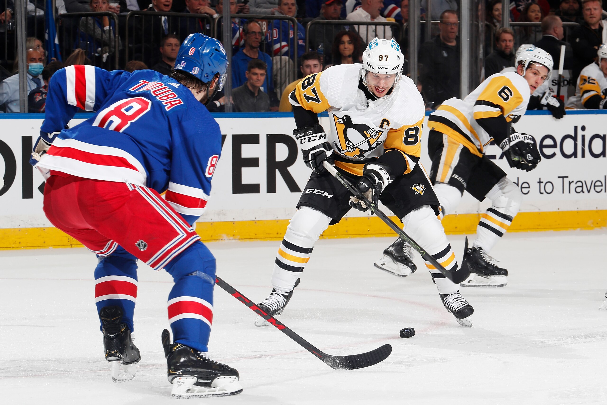 NEW YORK, NEW YORK - MAY 11: Sidney Crosby #87 of the Pittsburgh Penguins play the puck against Jacob Trouba #8 of the New York Rangers in Game Five of the First Round of the 2022 Stanley Cup Playoffs at Madison Square Garden on May 11, 2022 in New York City. (Photo by Jared Silber/NHLI via Getty Images)