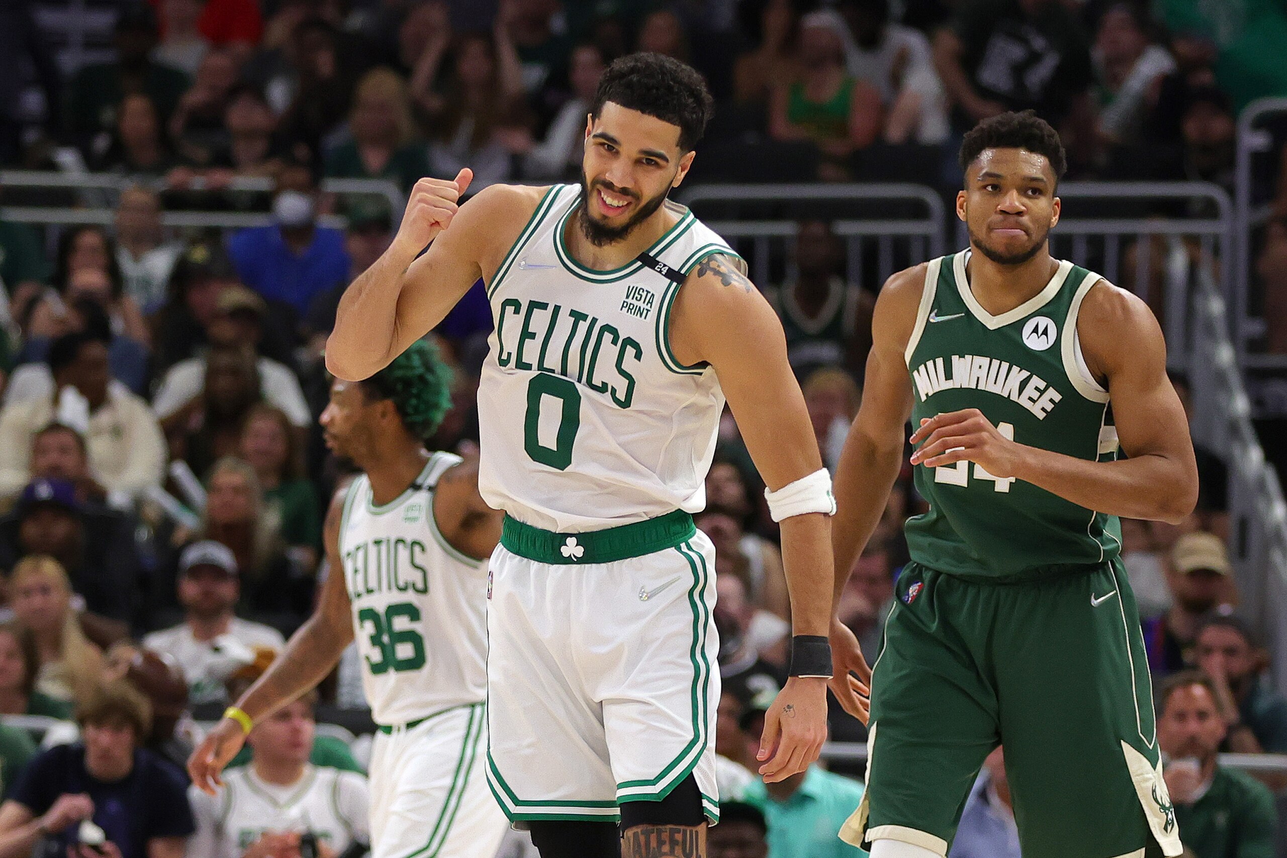 MILWAUKEE, WISCONSIN - MAY 13: Jayson Tatum #0 of the Boston Celtics celebrates a basket against Giannis Antetokounmpo #34 of the Milwaukee Bucks during the third quarter in Game Six of the 2022 NBA Playoffs Eastern Conference Semifinals at Fiserv Forum on May 13, 2022 in Milwaukee, Wisconsin. NOTE TO USER: User expressly acknowledges and agrees that, by downloading and/or using this photograph, User is consenting to the terms and conditions of the Getty Images License Agreement. (Photo by Stacy Revere/Getty Images)