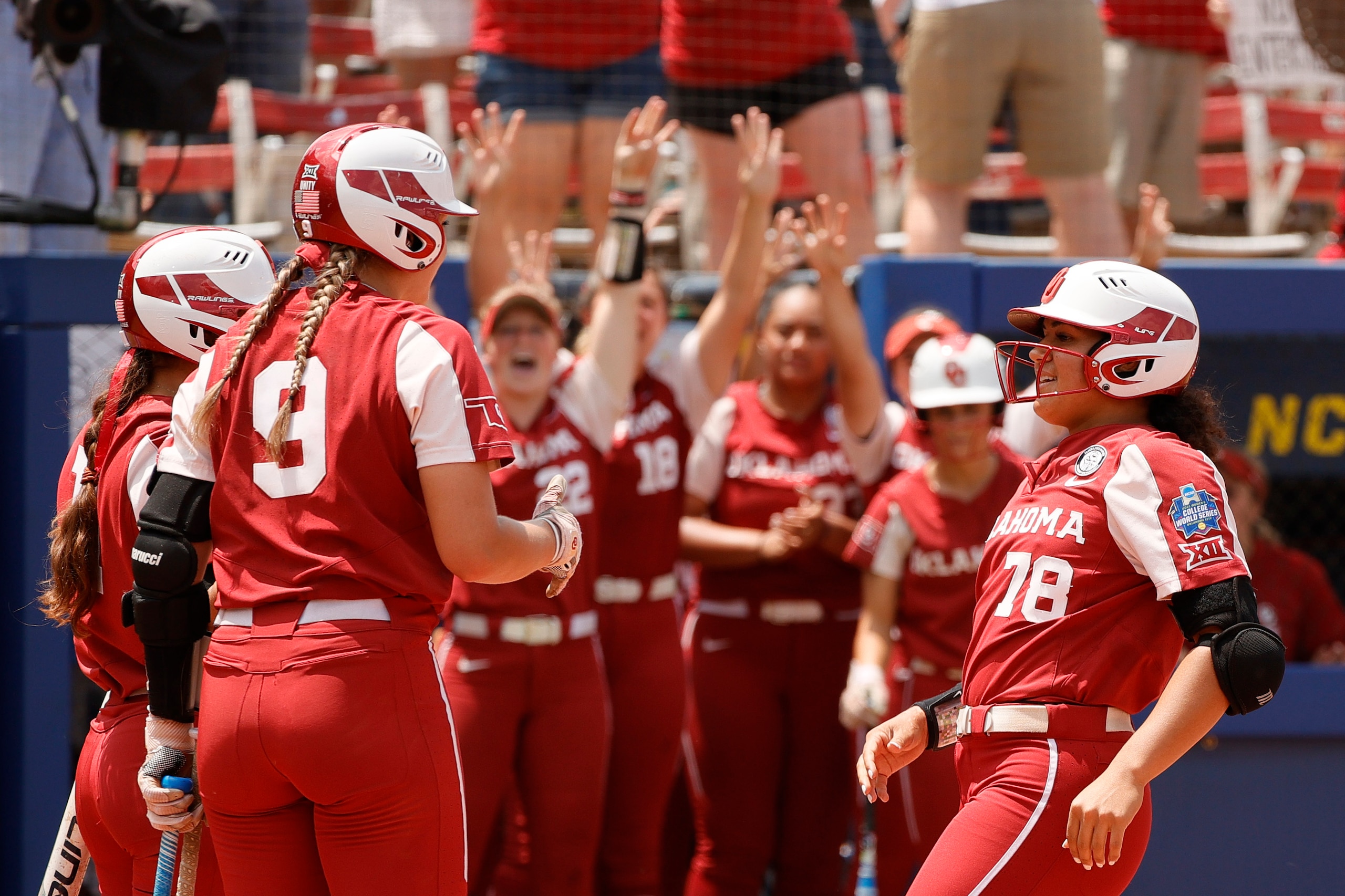 OKLAHOMA CITY, OKLAHOMA - JUNE 10: Jocelyn Alo #78 of the Oklahoma Sooners reacts with teammates as she scores on a solo home run during the first inning of Game 3 of the Women's College World Series Championship against the Florida St. Seminoles at USA Softball Hall of Fame Stadium on June 10, 2021 in Oklahoma City, Oklahoma. (Photo by Sarah Stier/Getty Images)
