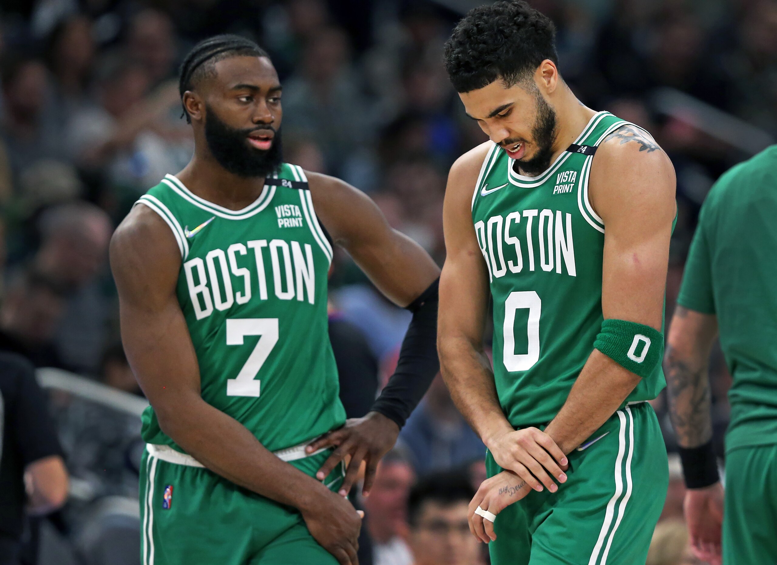 Milwaukee - May 7: The Celtics Jayson Tatum (right) heads for the sidelines holding his left wrist after appearing to hurt it on a first half slam dunk and subsequent fall to the floor. Teammate Jaylen Brown is at left.  The Boston Celtics visited the Milwaukee Bucks for Game Three of their NBA basketball Eastern Conference Semi-Final series at Fiserv Forum in Milwaukee, WI on May 7, 2022. (Photo by Jim Davis/The Boston Globe via Getty Images)
