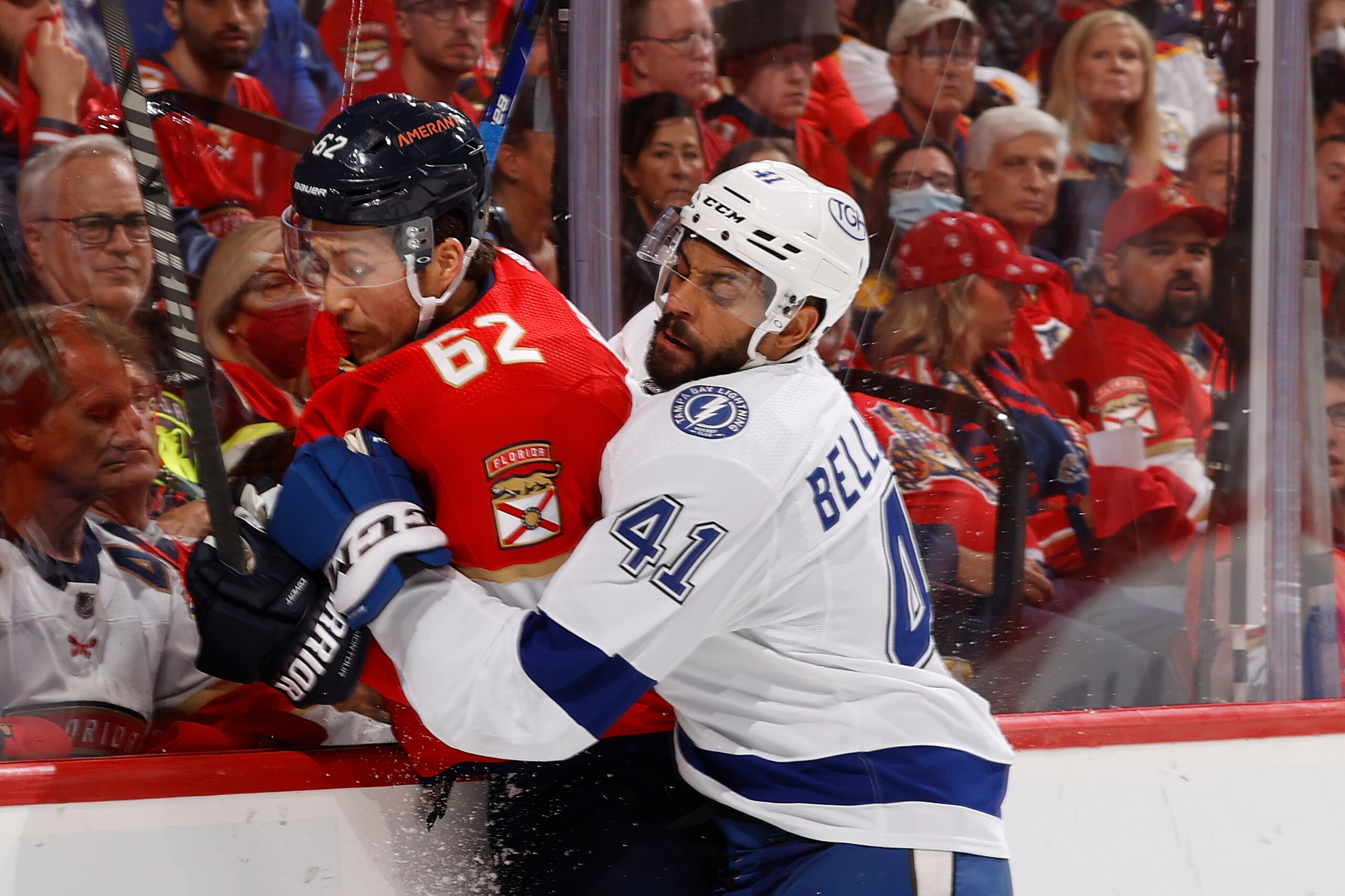 SUNRISE, FL - MAY 17: Pierre-Edouard Bellemare #41 of the Tampa Bay Lightning checks Brandon Montour #62 of the Florida Panthers into the boards during second period action in Game One of the Second Round of the 2022 NHL Stanley Cup Playoffs at the FLA Live Arena on May 17, 2022 in Sunrise, Florida. (Photo by Joel Auerbach/Getty Images)
