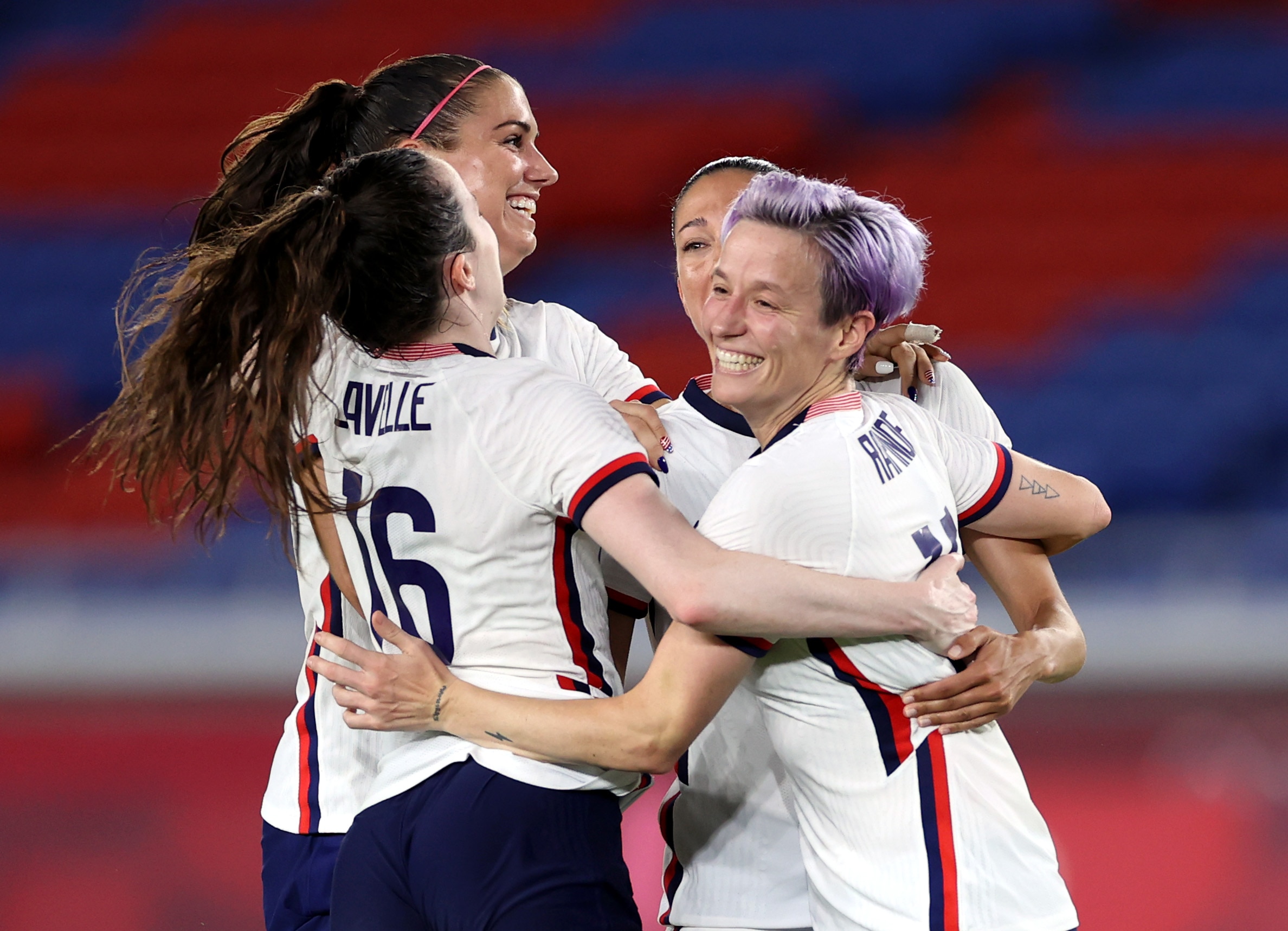 YOKOHAMA, JAPAN - JULY 30: Rose Lavelle #16, Alex Morgan #13, Christen Press #11 and Megan Rapinoe #15 of Team United States celebrate following their team's victory in the penalty shoot out after the Women's Quarter Final match between Netherlands and United States on day seven of the Tokyo 2020 Olympic Games at International Stadium Yokohama on July 30, 2021 in Yokohama, Kanagawa, Japan. (Photo by Laurence Griffiths/Getty Images)