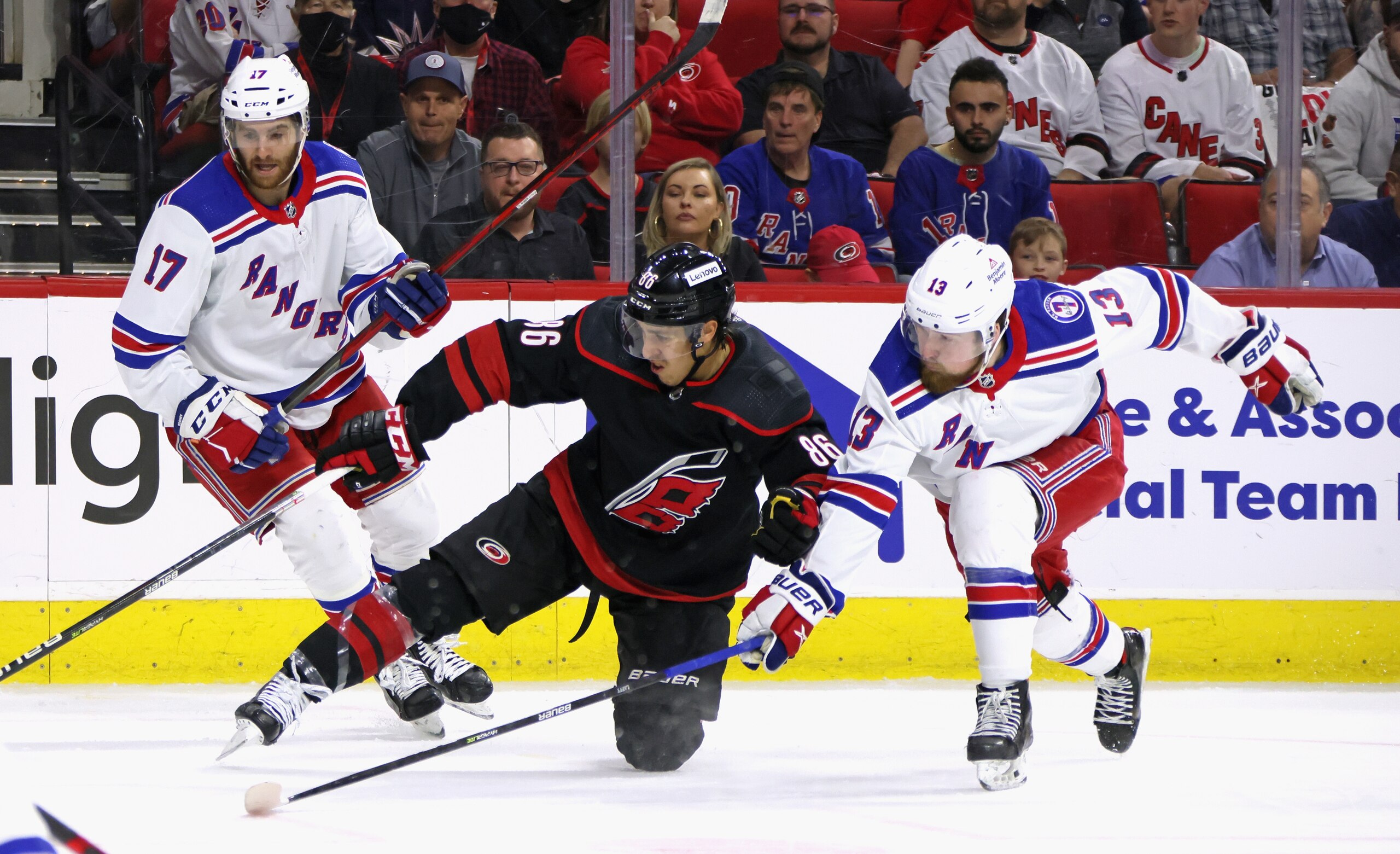 RALEIGH, NORTH CAROLINA - MAY 18: Teuvo Teravainen #86 of the Carolina Hurricanes is checked by Alexis Lafreniere #13 of the New York Rangers during the second period in Game One of the Second Round of the 2022 Stanley Cup Playoffs  at PNC Arena on May 18, 2022 in Raleigh, North Carolina. (Photo by Bruce Bennett/Getty Images)
