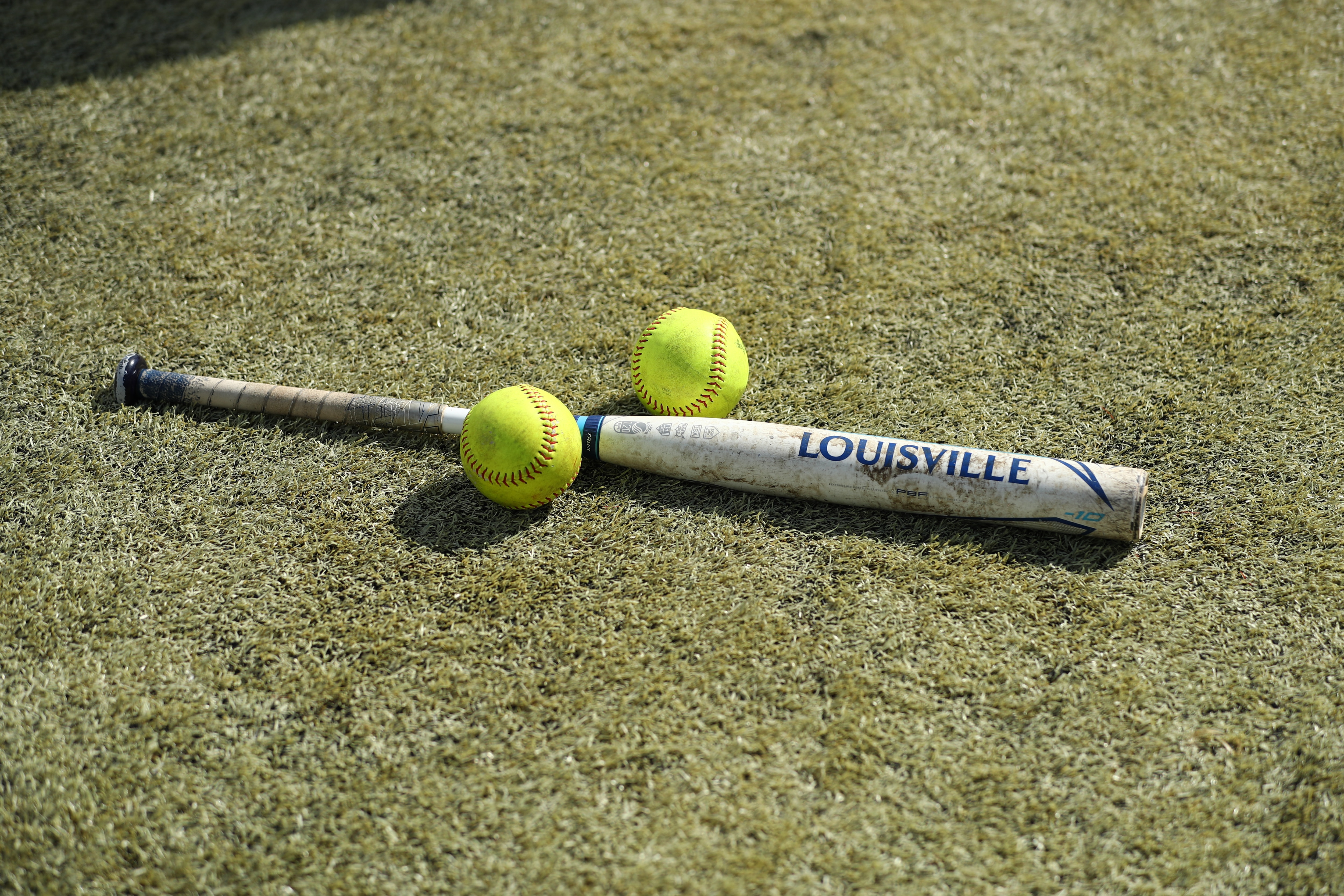 DENVER, CO - JUNE 1: Softballs and a bat rest on the ground before game 3 of the Division II Women's Softball Championship between Biola Eagles and West Texas A&M Buffs held at The Regency Athletic Complex at MSU on June 1, 2021 in Denver, Colorado. The West Texas A&M Buffs defeated the Biola Eagles, 4-1. (Photo by C. Morgan Engel/NCAA Photos via Getty Images) DENVER, CO - JUNE 1: Softballs and a bat rest on the ground before game 3 of the Division II Women's Softball Championship between Biola Eagles and West Texas A&M Buffs held at The Regency Athletic Complex at MSU on June 1, 2021 in Denver, Colorado. The West Texas A&M Buffs defeated the Biola Eagles, 4-1. (Photo by C. Morgan Engel/NCAA Photos via Getty Images)