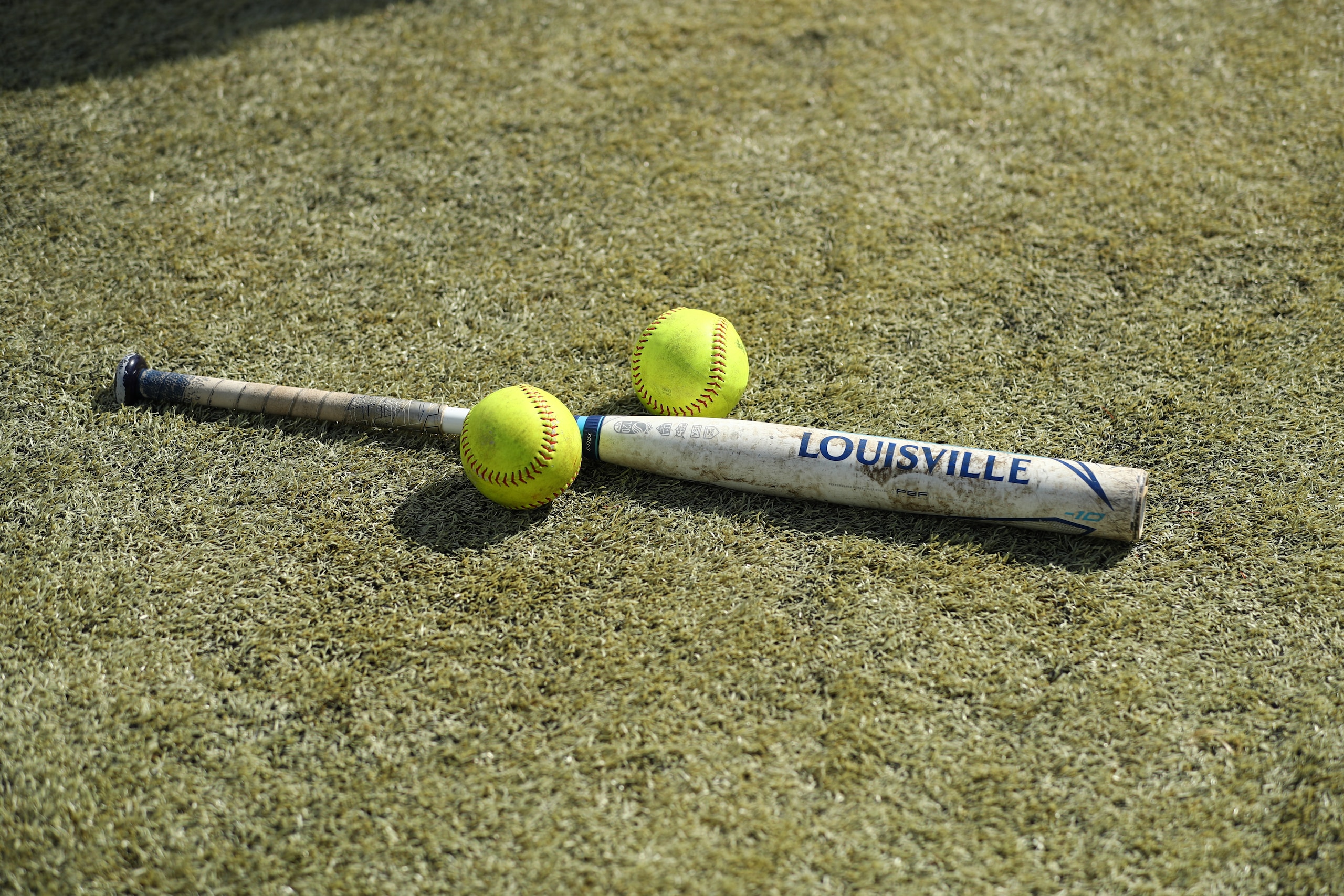 DENVER, CO - JUNE 1: Softballs and a bat rest on the ground before game 3 of the Division II Women's Softball Championship between Biola Eagles and West Texas A&M Buffs held at The Regency Athletic Complex at MSU on June 1, 2021 in Denver, Colorado. The West Texas A&M Buffs defeated the Biola Eagles, 4-1.  (Photo by C. Morgan Engel/NCAA Photos via Getty Images)
