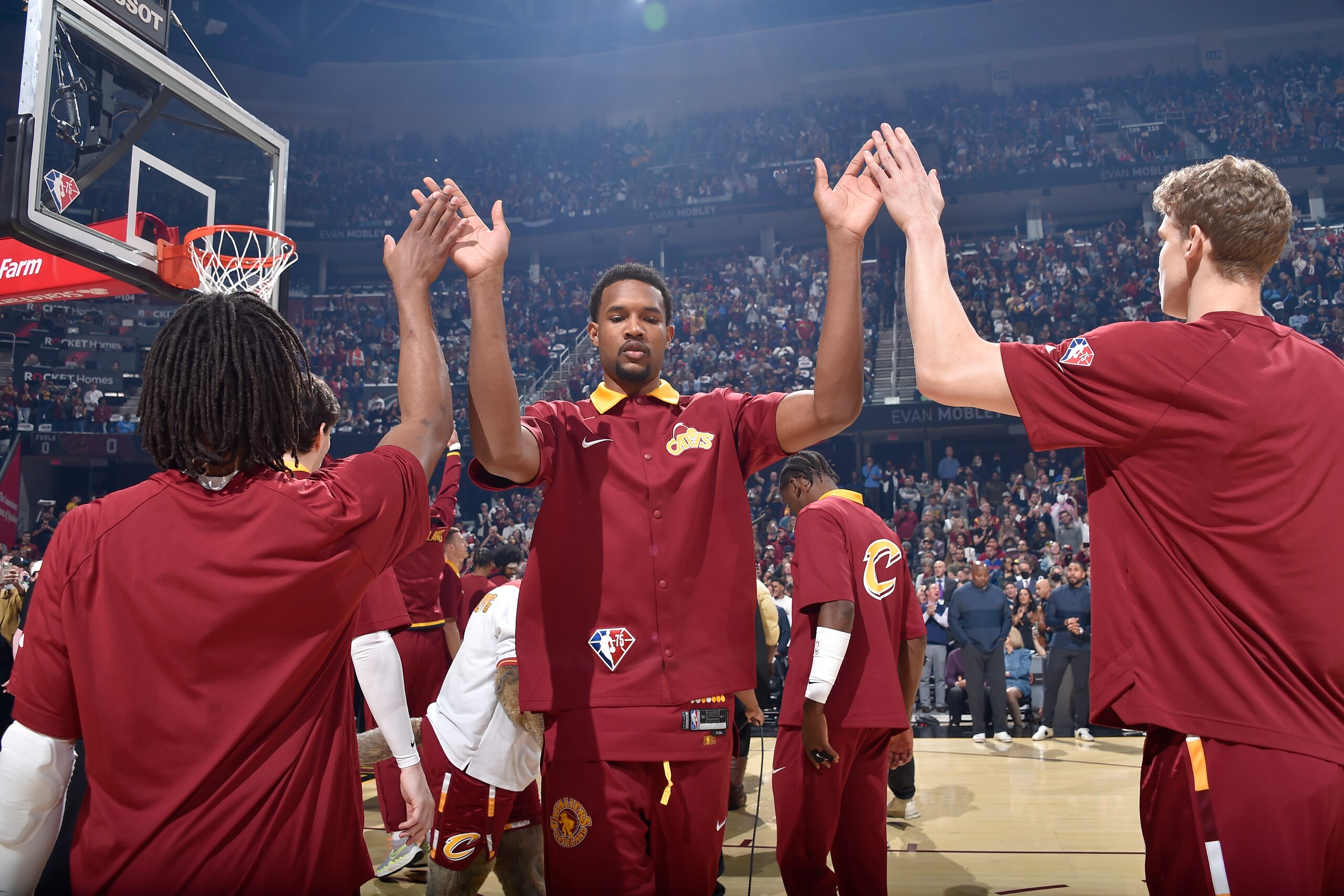 CLEVELAND, OH - APRIL 15: Darius Garland #10 and Lauri Markkanen #24 of the Cleveland Cavaliers embrace Evan Mobley #4 of the Cleveland Cavaliers before the 2022 Play-In Tournament on April 15, 2022 at Rocket Mortgage FieldHouse in Cleveland, Ohio. NOTE TO USER: User expressly acknowledges and agrees that, by downloading and/or using this Photograph, user is consenting to the terms and conditions of the Getty Images License Agreement. Mandatory Copyright Notice: Copyright 2022 NBAE (Photo by David Liam Kyle/NBAE via Getty Images)